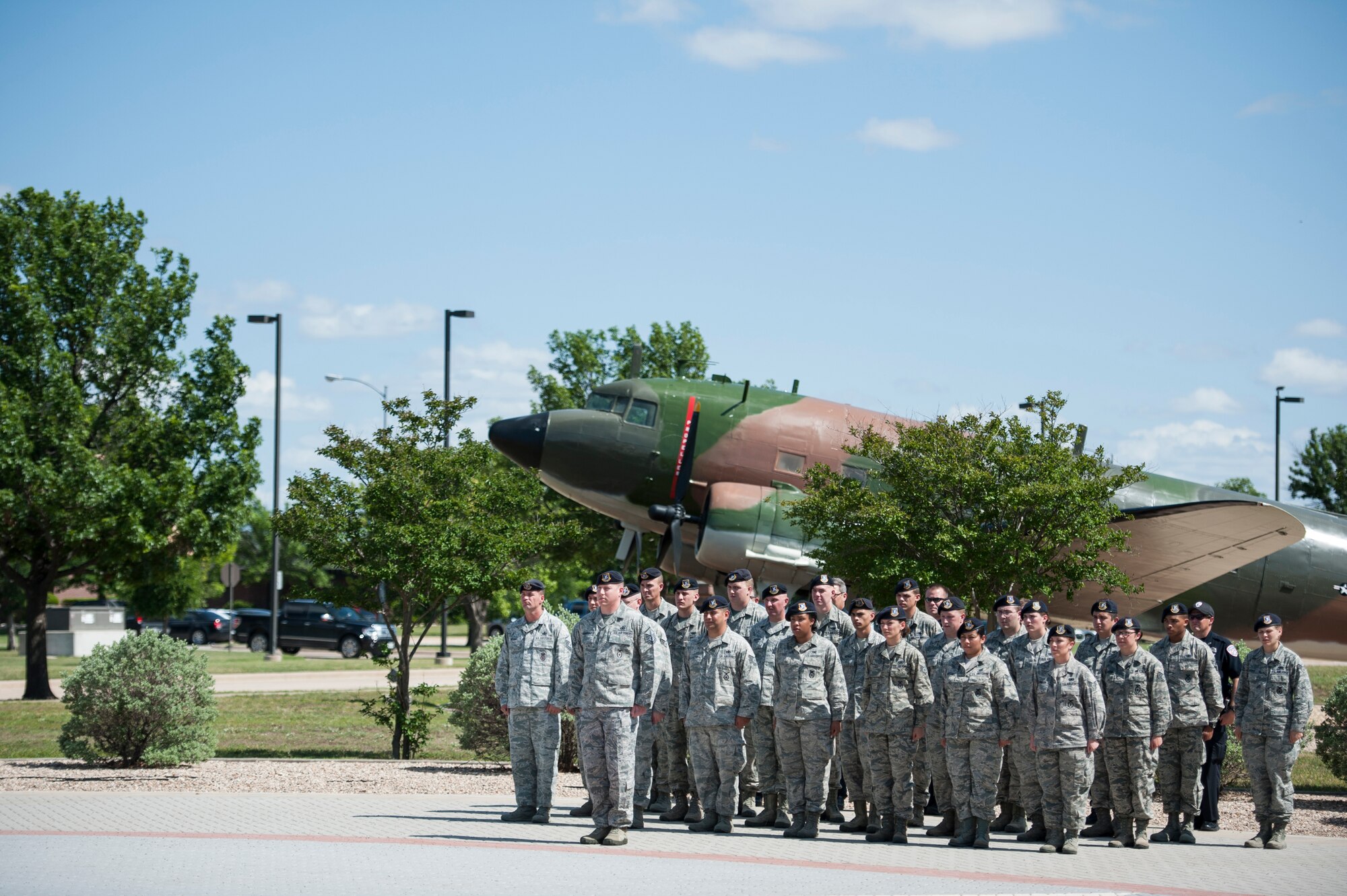 Members of the 17th Security Forces Squadron and San Angelo Police Department stand in formation during the National Police Week Retreat Ceremony in front of the Norma Brown Building on Goodfellow Air Force Base, Texas, May 15, 2015. The 17th SFS and SAPD came together and held a retreat ceremony to commemorate Peace Officers Memorial Day and National Police Week. (U.S. Air Force photo by Senior Airman Michael Smith/Released)