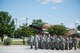 Members of the 17th Security Forces Squadron and San Angelo Police Department stand in formation during the National Police Week Retreat Ceremony in front of the Norma Brown Building on Goodfellow Air Force Base, Texas, May 15, 2015. The 17th SFS and SAPD came together and held a retreat ceremony to commemorate Peace Officers Memorial Day and National Police Week. (U.S. Air Force photo by Senior Airman Michael Smith/Released)