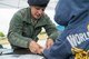 U.S. Air Force Staff Sgt. Traci J. Lara, 17th Security Forces Squadron patrol member, applies ink to a youth’s finger at the Police Week fingerprinting for children event on Goodfellow Air Force Base, Texas, May 12, 2015. Parents had the option of having the fingerprints entered into the Federal BI's database for children aiding in the location of missing, abducted and runaway children. (U.S. Air Force photo by Senior Airman Michael Smith/Released)