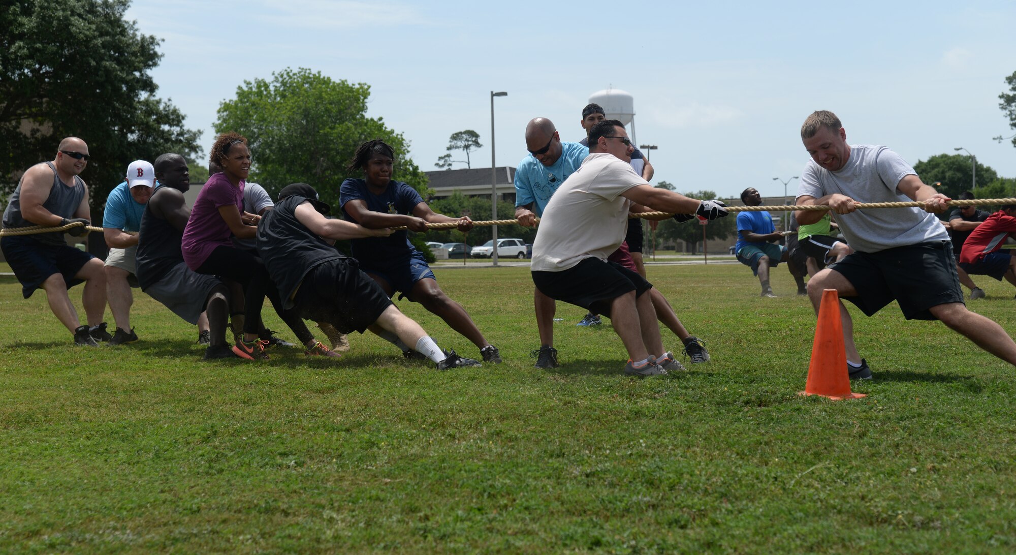 Members of the 81st Wing Staff Agency pull together in the tug-of-war challenge at Keesler Sports Day, May 15, 2015, Keesler Air Force Base, Miss. Members of Team Keesler participated in different sports throughout the day including, sand volleyball and the last man standing push-up challenge to celebrate National Fitness and Sports Month. (U.S. Air Force photo by Senior Airman Holly Mansfield)