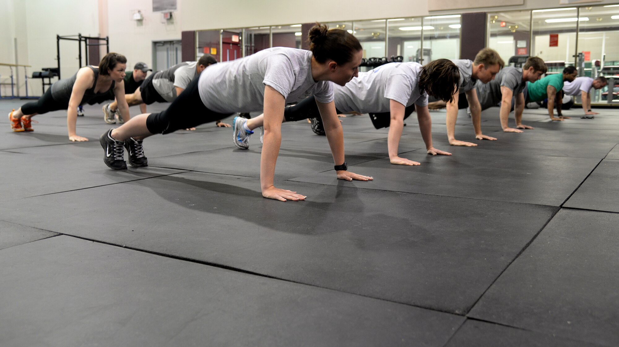 Airmen from the 334th Training Squadron and the 81st Logistics Readiness Squadron compete in the last man standing push-up challenge at Keesler Sports Day, May 15, 2015, Keesler Air Force Base, Miss. Members of Team Keesler participated in different sports throughout the day including, sand volleyball and the last man standing push-up challenge to celebrate National Fitness and Sports Month. (U.S. Air Force photo by Senior Airman Holly Mansfield)