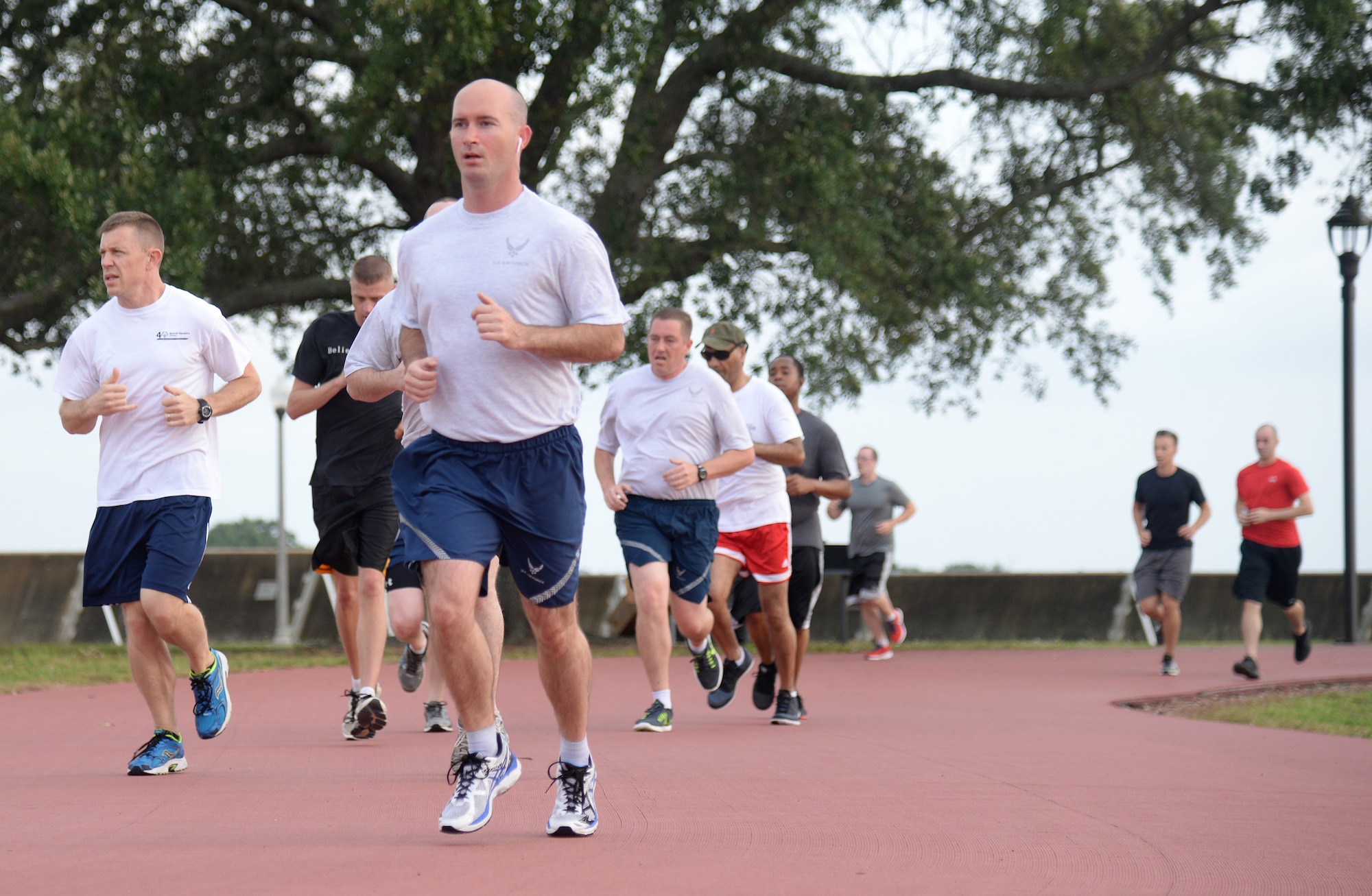 Airmen run during a 5K at Keesler Sports Day, May 15, 2015, Keesler Air Force Base, Miss. Members of Team Keesler participated in different sports throughout the day including, sand volleyball and the last man standing push-up challenge to celebrate National Fitness and Sports Month. (U.S. Air Force photo by Senior Airman Holly Mansfield)