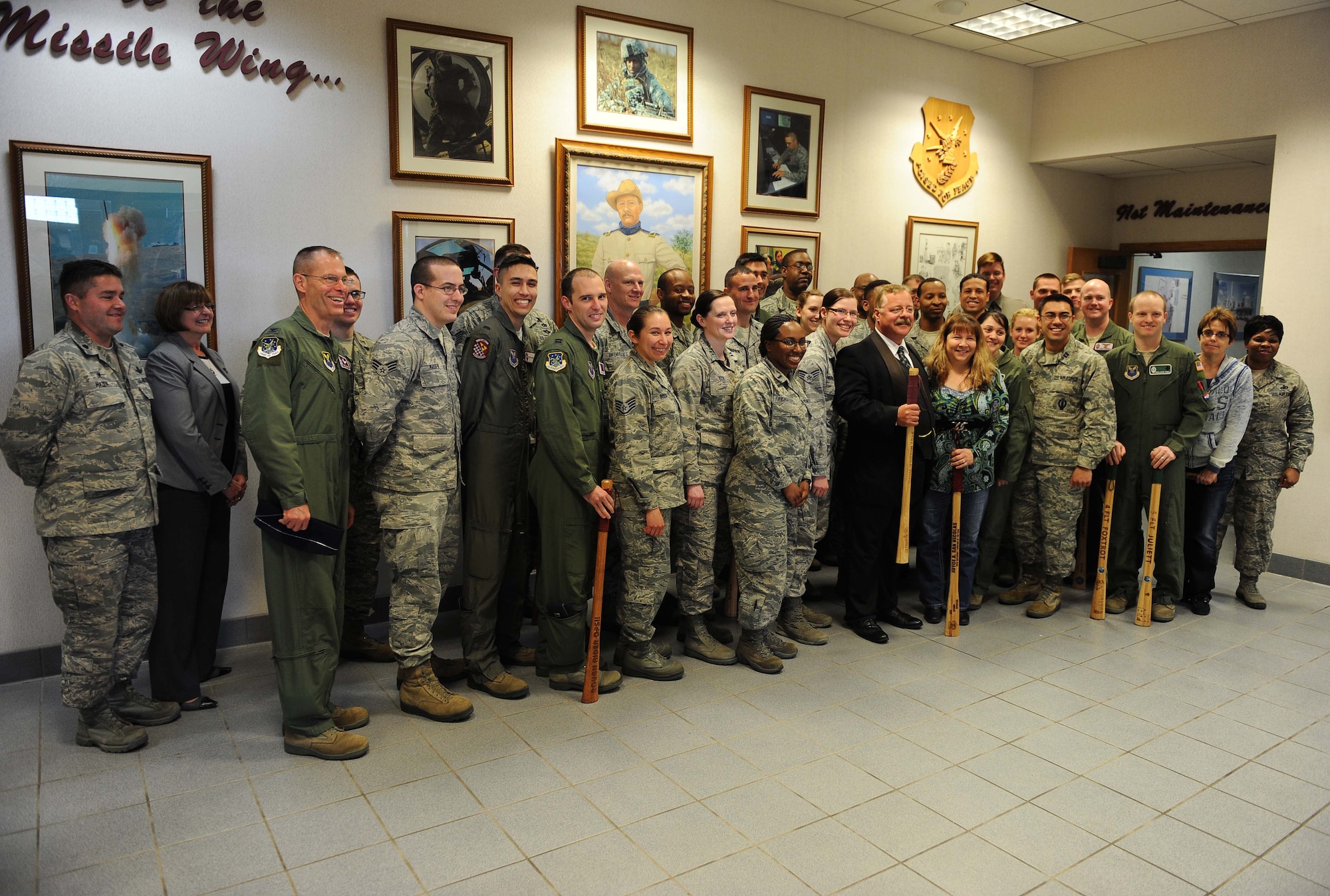 President Teddy Roosevelt, portrayed by Joe Wiegand, poses for a group photo at the 91st Missile Wing headquarters building on Minot Air Force Base, N.D., May 7, 2015. During his visit, Teddy also toured Uniform-01 and stopped at 91st Missile Wing headquarters to visit with Airmen and learn about their mission. (U.S. Air Force photo/Senior Airman Kristoffer Kaubisch)