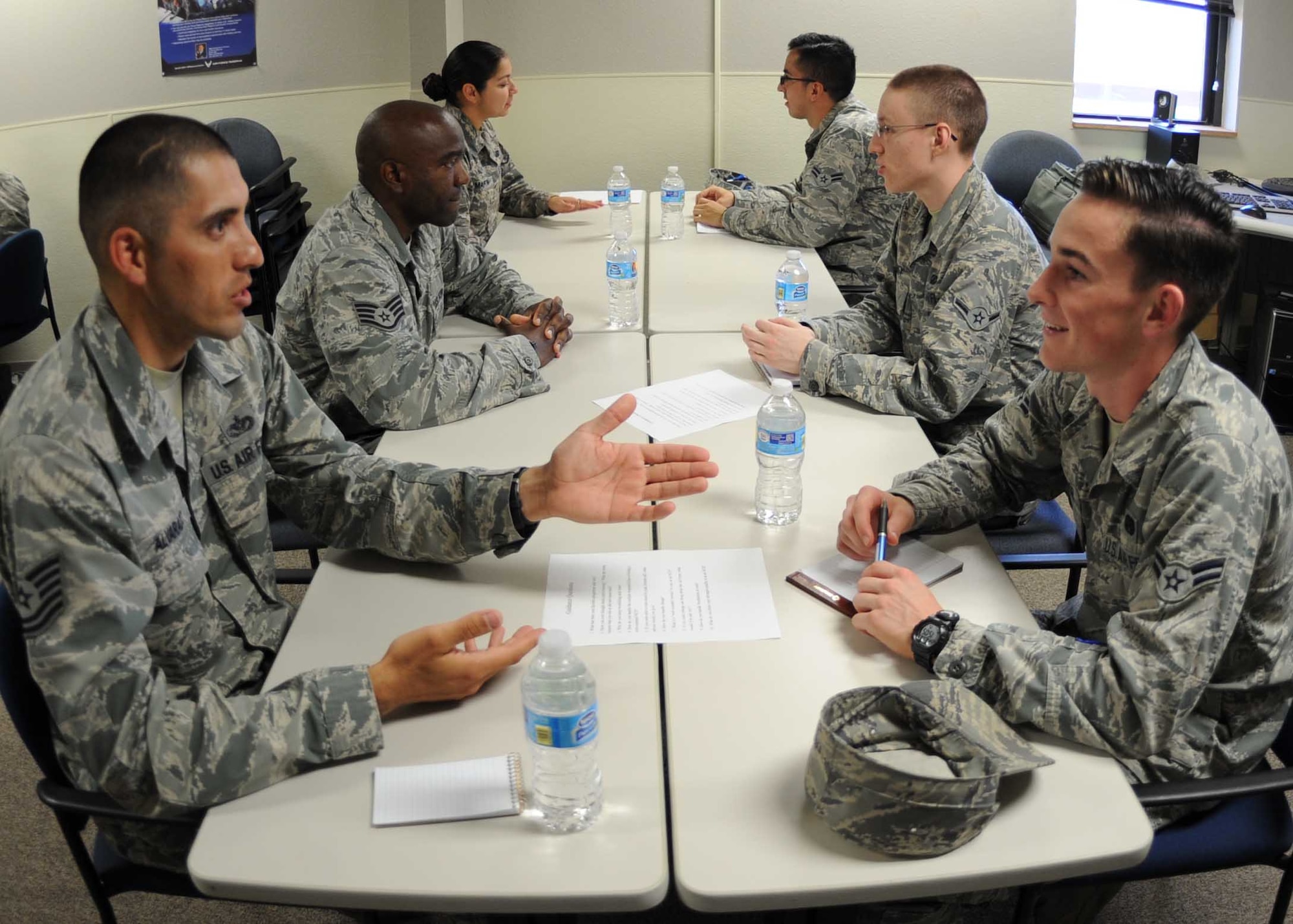 Airmen and non-commissioned officers interact during a mentoring event 7 April, 2015, at Dyess Air Force Base, Texas. The goal of the Speed Mentorship program is to open communication and networking lines between Airmen and NCO tiers, foster cross-AFSC mentoring and help all participants develop as individuals. (U.S. Air Force photo by Senior Airman Shannon Hall/Released)