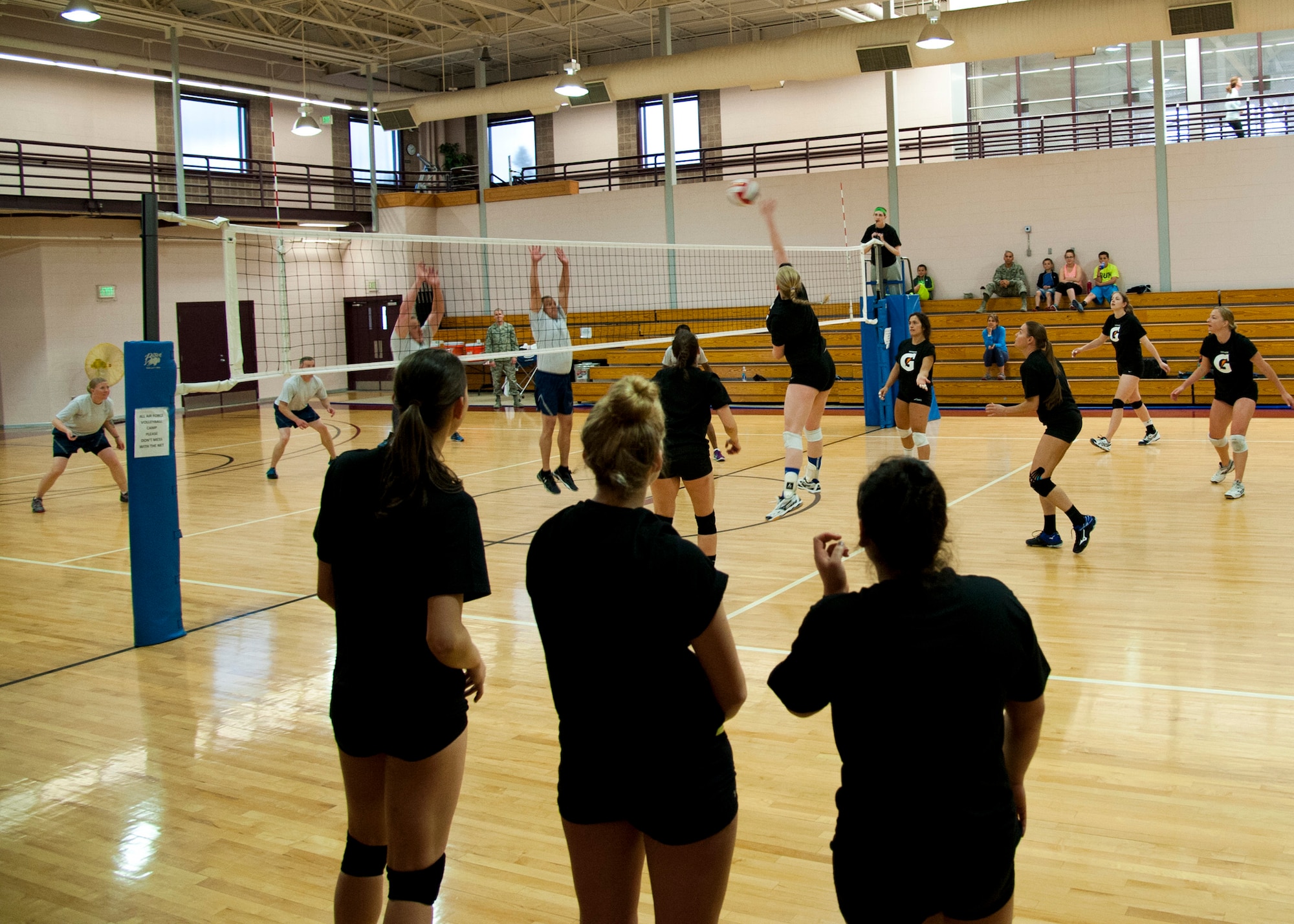PETERSON AIR FORCE BASE, Colo. – Members of the Air Force female volleyball team play a scrimmage match against some of the Peterson chief master sergeants and first sergeants May 13, 2015. The female team won 2-1. The Air Force female volleyball team held their try-outs and practices at the fitness center from May 4-21 before the Armed Forces Volleyball Tournament in Detroit, Michigan. (U.S. Air Force photo by Senior Airman Tiffany DeNault)