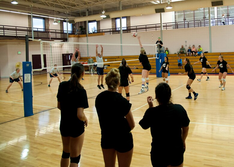 PETERSON AIR FORCE BASE, Colo. – Members of the Air Force female volleyball team play a scrimmage match against some of the Peterson chief master sergeants and first sergeants May 13, 2015. The female team won 2-1. The Air Force female volleyball team held their try-outs and practices at the fitness center from May 4-21 before the Armed Forces Volleyball Tournament in Detroit, Michigan. (U.S. Air Force photo by Senior Airman Tiffany DeNault)