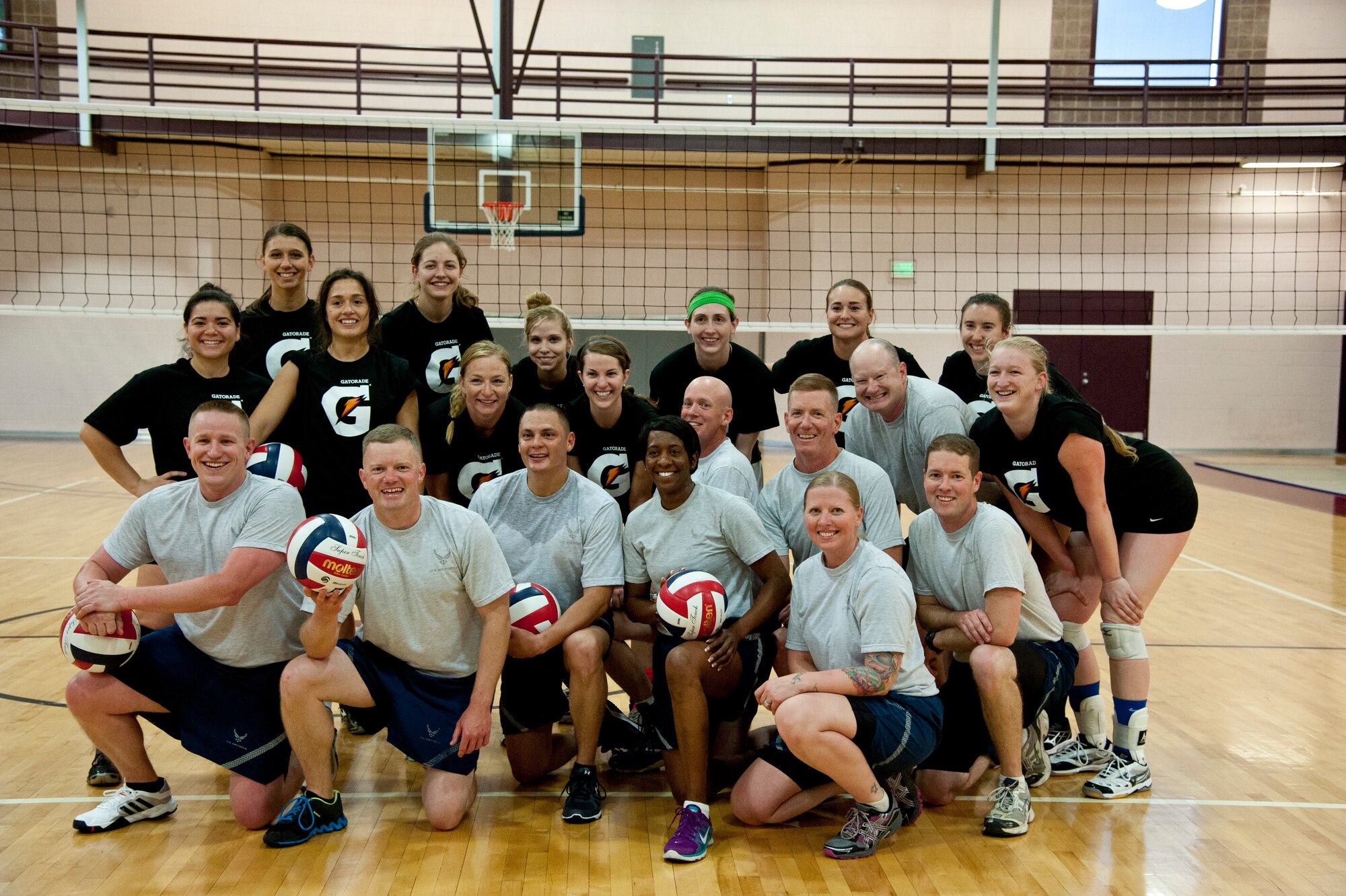 PETERSON AIR FORCE BASE, Colo. – Members of the Air Force female volleyball team pose with Peterson chief master sergeants and first sergeants after a scrimmage match where the female team won 2-1 at the Peterson Fitness Center May 13, 2015. The Air Force female volleyball team held their try-outs and practices at the fitness center from May 4-21 before the Armed Forces Volleyball Tournament in Detroit, Michigan. (U.S. Air Force photo by Senior Airman Tiffany DeNault)