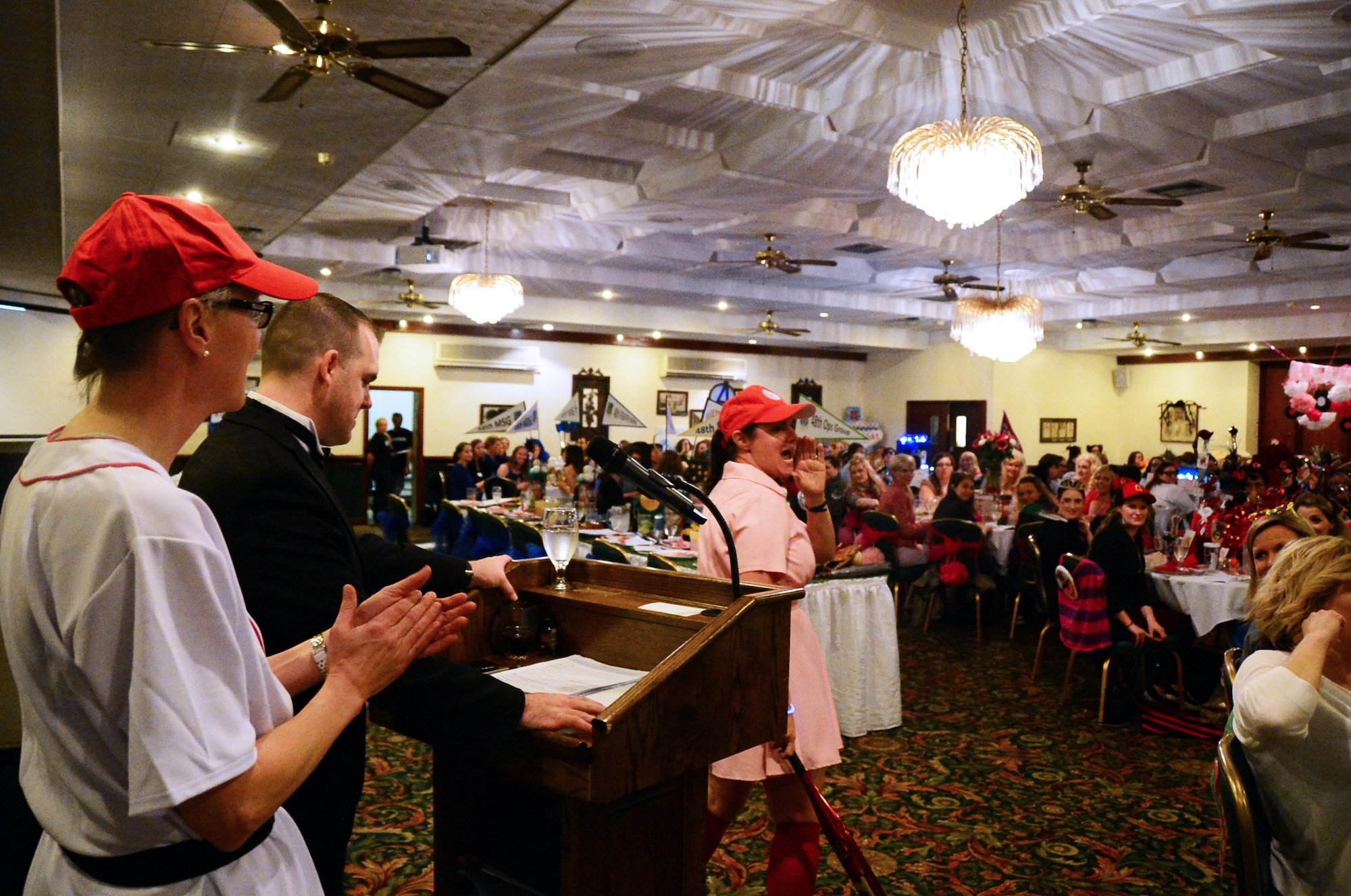 Diana Stuart, spouse of Col. Brian Stuart, 48th Maintenance Group commander, calls for her team during the Liberty Spouses Dining-In at Royal Air Force Lakenheath, England, May 8, 2015. More than 160 Liberty Wing spouses participated in the movie-themed event, which consisited of Liberty Oscar competitions in spirit, skits, costumes and table decorating table decorating. (U.S. Air Force photo by Senior Airman Erin O’Shea/Released) 
