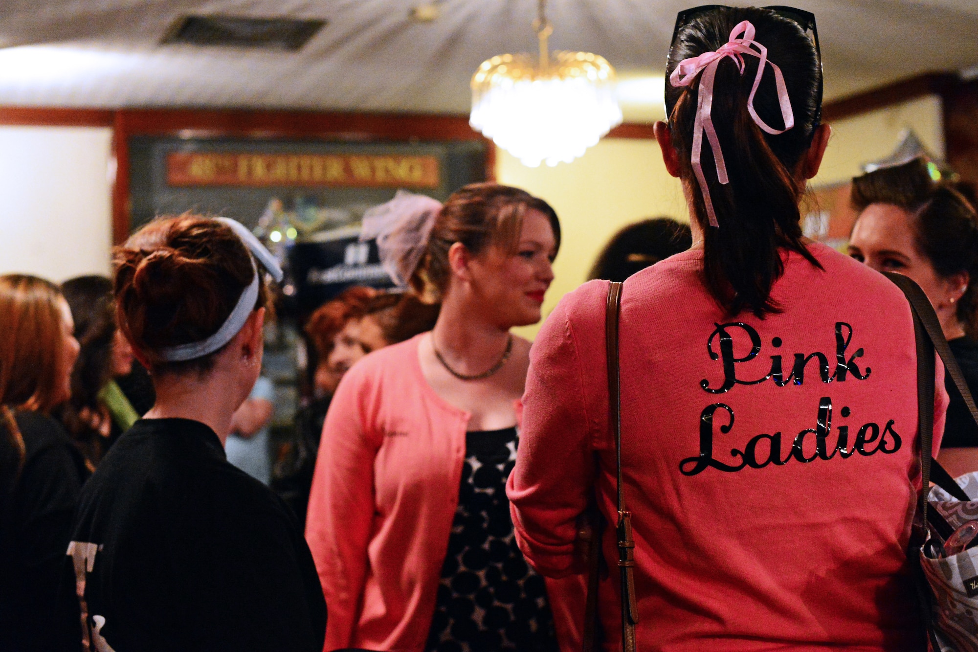48th Fighter Wing spouses mingle during the Liberty Spouses Dining-In social hour at Royal Air Force Lakenheath, England, May 8, 2015. The movie-themed event gave spouses from around the wing the opportunity to interact with other participants both in their unit and across the greater spouse community. (U.S. Air Force photo by Senior Airman Erin O’Shea/Released)