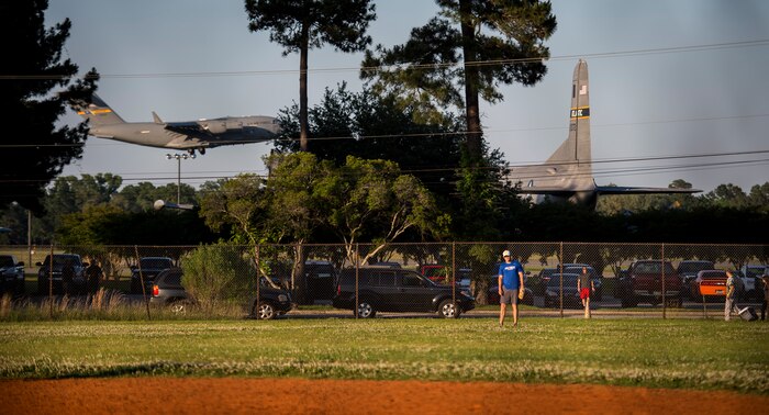 A C-17 Globemaster III prepares to land in the background during an Intramural Softball game, May 13, 2015 at Joint Base Charleston – Air Base, S.C. Joint Base Charleston’s 2015 Intramural Softball Season is expected to run till mid-June. (U.S. Air Force photo/Airman 1st Class Clayton Cupit)