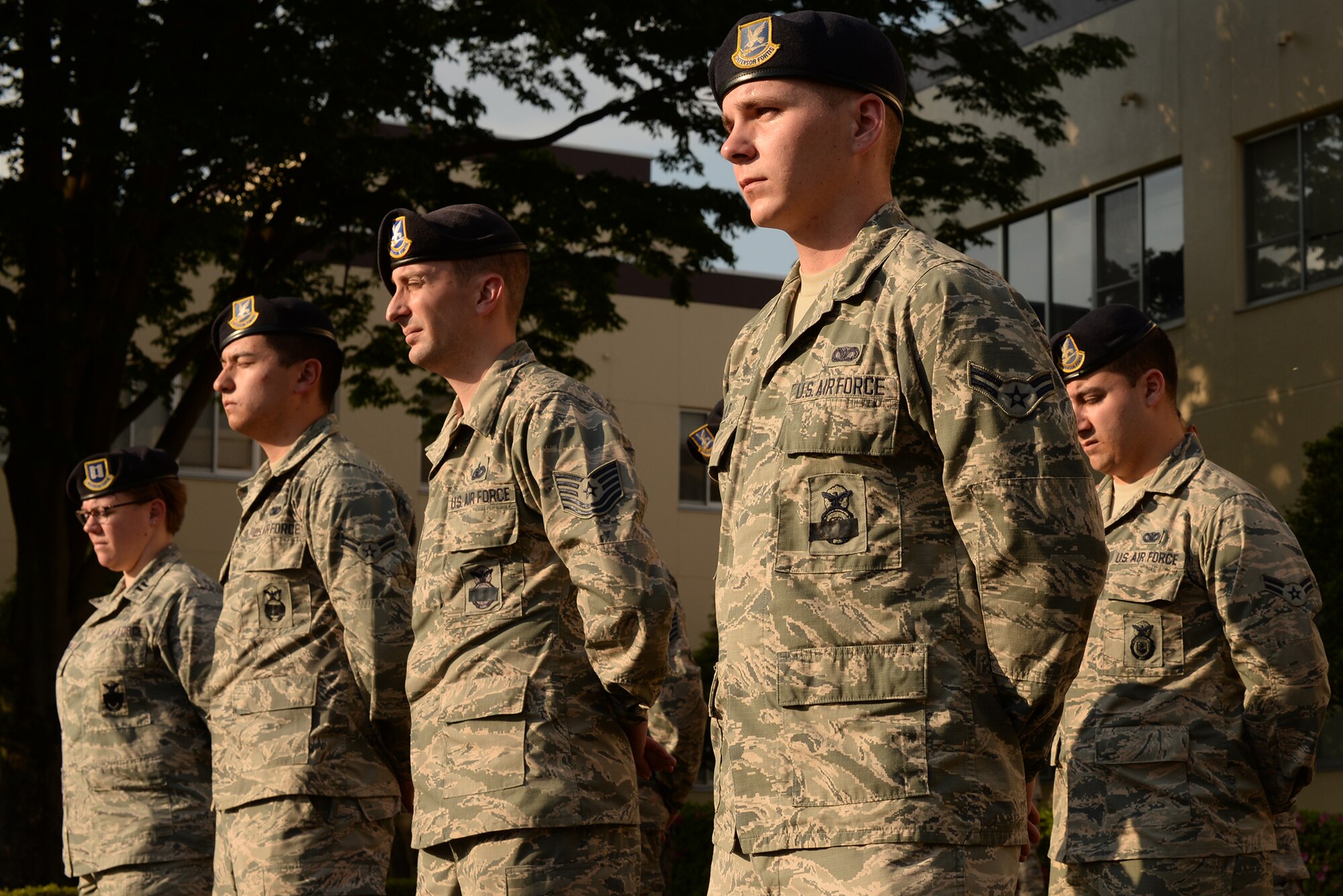 Members of the 374th Security Forces Squadron stand at parade rest during a retreat ceremony at Yokota Air Base, Japan, May 13, 2015. The ceremony was held to honor fallen law enforcement officers as part of Police Week. (U.S. Air Force photo by Airman 1st Class Elizabeth Baker/Released)