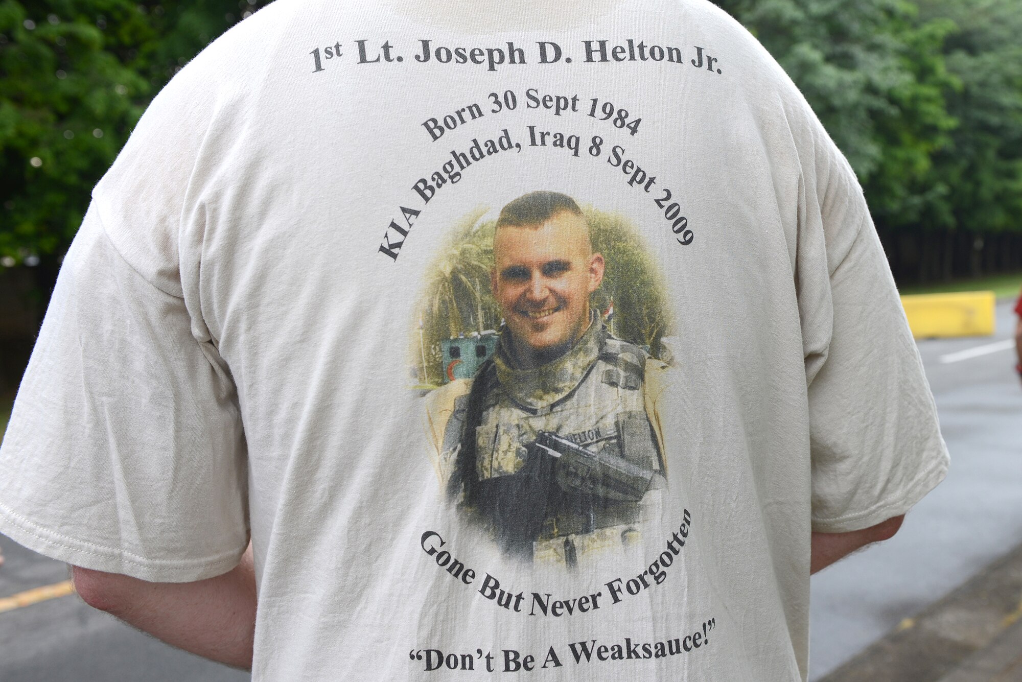 A member of the 374th Security Forces Squadron wears a shirt honoring a fallen defender during the Police Week 5K run at Yokota Air Base, Japan, May 12, 2015. This year the 374 SFS used Police Week to pay tribute to the 10 Security Forces Airmen who have been killed in action since 9/11. (U.S. Air Force photo by Airman 1st Class David C. Danford/Released)