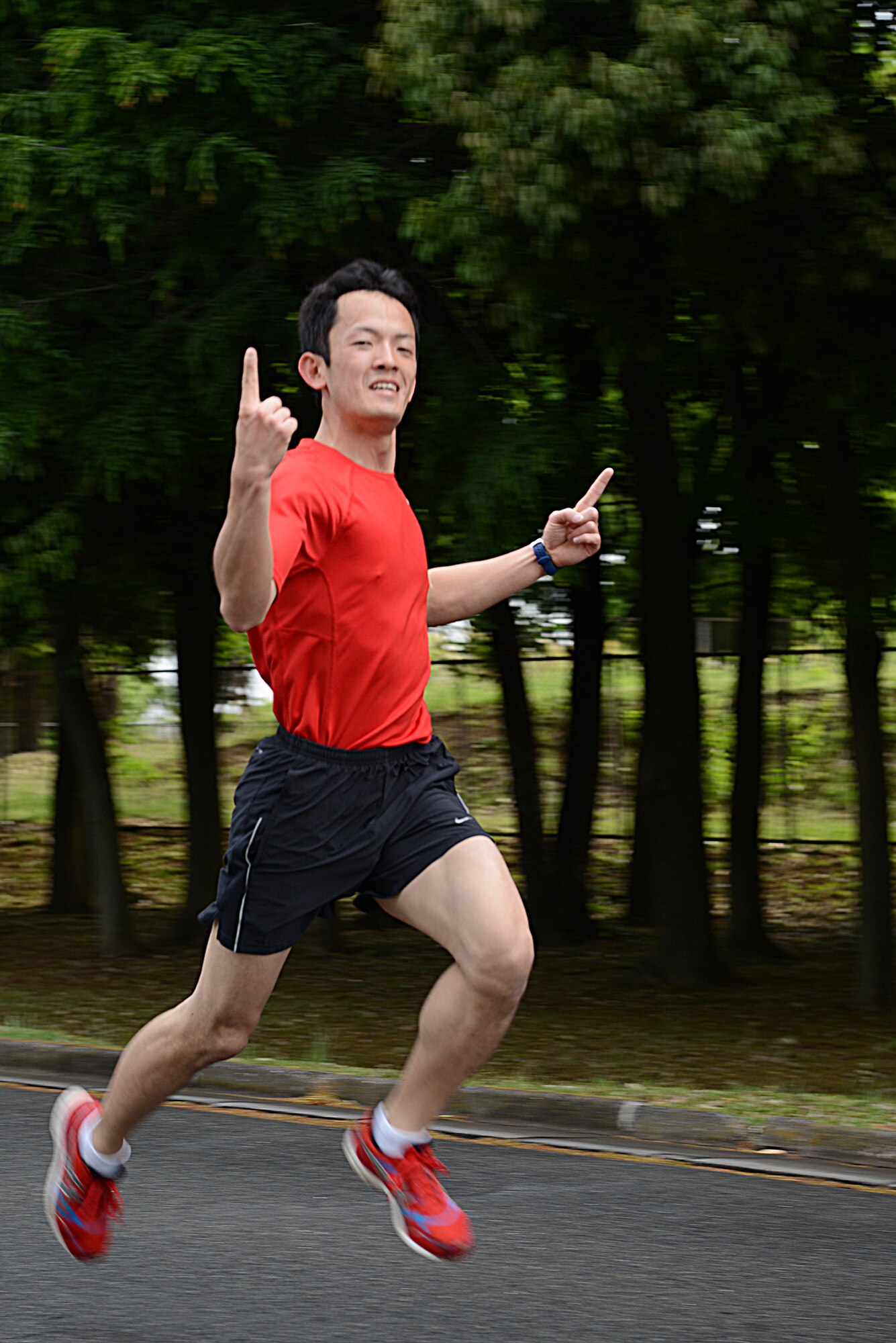 Japan Air Self-Defense Force 2nd Lt. Ninaga Kotaro finishes the Police Week 5K in first place at Yokota Air Base, Japan, May 12, 2015. Kotaro was presented with a 374th Security Forces Squadron coin for his performance. (U.S. Air Force photo by Airman 1st Class David C. Danford/Released)