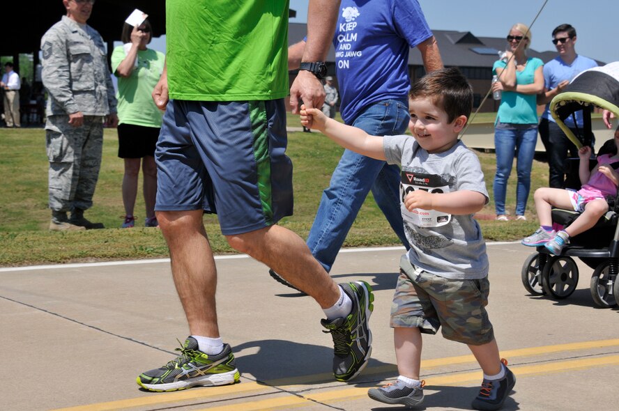 Clay Howerton and his father, Lt. Col. Troy Howerton, participate in the 3rd Annual Hawg Jawg held May 2, 2015, as part of a Family Day event on Ebbing Air National Guard Base, Fort Smith, Ark. Family Day brought together Guard family, friends and community members to celebrate those who support their Airmen every day. (U.S. Air National Guard photo by Staff Sgt. John Suleski/released)
