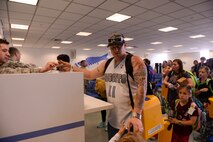 Military members and dependents assigned to Osan Air Base, Korea, process at Yokota Air Base, Japan, May 15, 2015. Dependents and personnel participated in a mock evacuation from Osan to Yokota during a simulated noncombatant evacuation exercise. (Airman 1st Class Elizabeth Baker/Released)