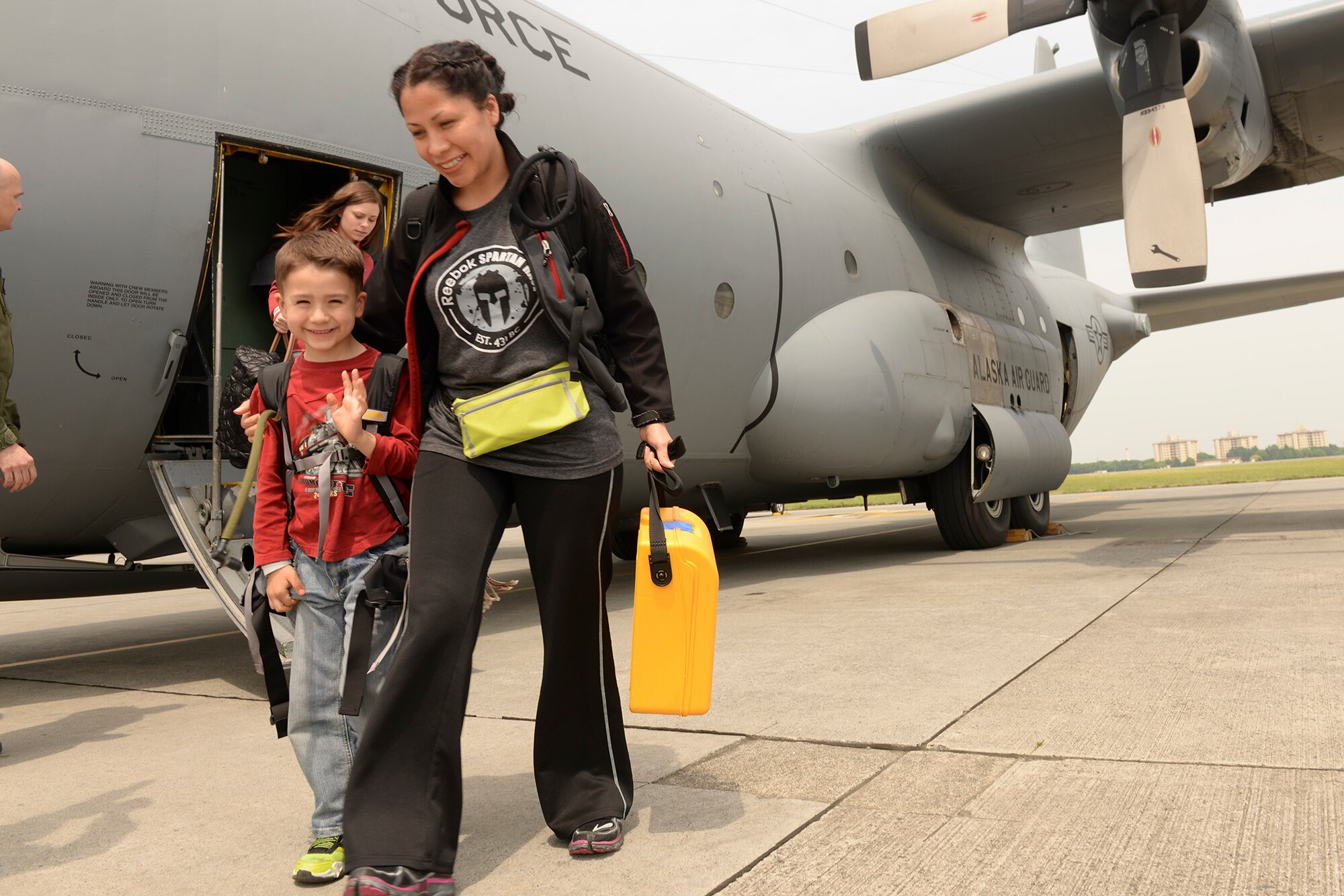 Military members and dependents living at Osan Air Base, Korea, arrive at Yokota Air Base, Japan, May 15, 2015. The dependents and military members went through the entire noncombatant evacuation process as part of a readiness inspection. (Airman 1st Class Elizabeth Baker/Released)