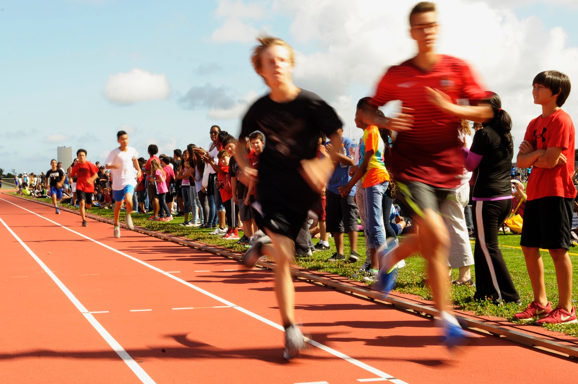Students from Kadena Middle School and Ryukyu Middle School race for the finish at the combined track day event at the Ryukyu Middle School track on Kadena Air Base, Japan, May 15, 2015. Students, parents, service members, community volunteers and Department of Defence Education Activity staff members were all in attendence to make this large event go smoothly to celebrate KMS and RMS’s combining slated to happen next year. (U.S. Air Force photo by Airman 1st Class Zackary A. Henry)