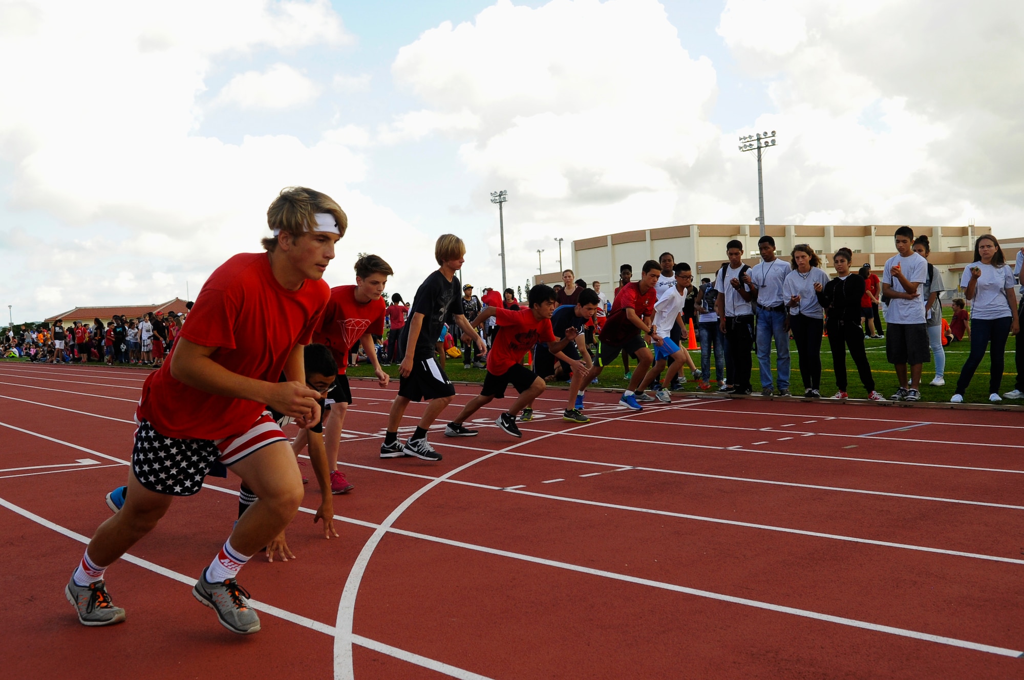 Eight students from Kadena Middle School and Ryukyu Middle School begin their 1600-meter race at the Ryukyu Middle School track on Kadena Air Base, Japan, May 15, 2015. The track event was held to celebrate the combining of KMS and RMS next year. The track day had more than 75 service members volunteering with more than 1,000 students in attendence. (U.S. Air Force photo by Airman 1st Class Zackary A. Henry)