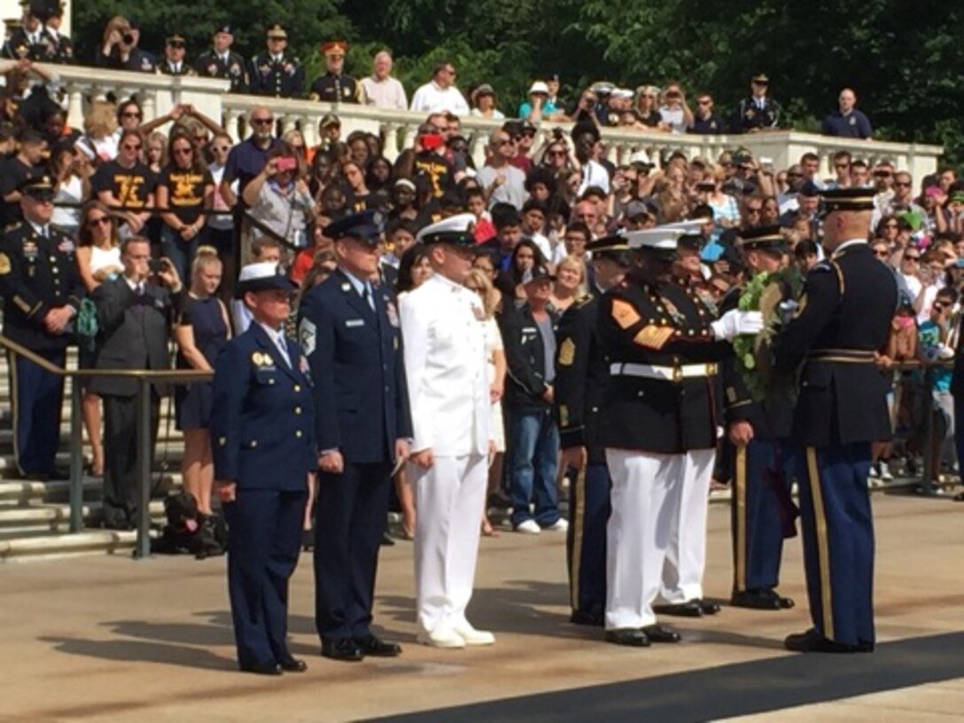Sergeant Major of the Marine Corps, Sgt. Maj. Ronald L. Green pins a medallion representing the Marine Corps on a wreath honoring members of the armed forces during an Armed Forces Day ceremony at Arlington National Cemetery in Arlington, Va., May 16, 2015.
