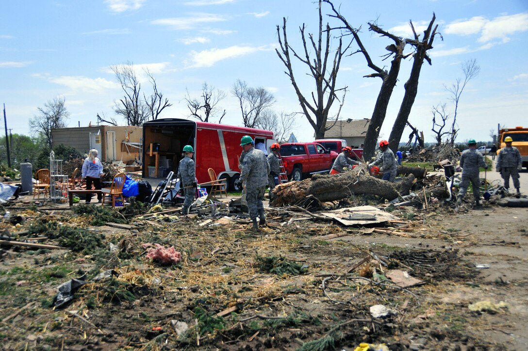 Airmen clear debris during tornado recovery efforts in Delmont, S.D., May 12, 2015.