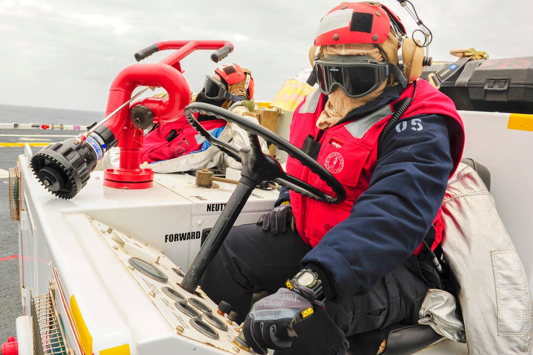 U.S. Navy Petty Officer 3rd Class Ida Miller starts the engine of a P-25 fire truck on the flight deck of the amphibious assault ship USS Boxer in the Pacific Ocean, May 7, 2015. Miller is an aviation boatswain’s mate handling.