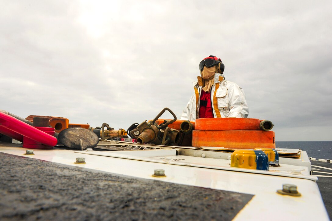 U.S. Navy Seaman Lawrence Pivec observes flight operations from a P-25 fire truck aboard the flight deck of the amphibious assault ship USS Boxer in the Pacific Ocean, May 7, 2015. Lawrence is an aviation boatswain’s mate handling airman.