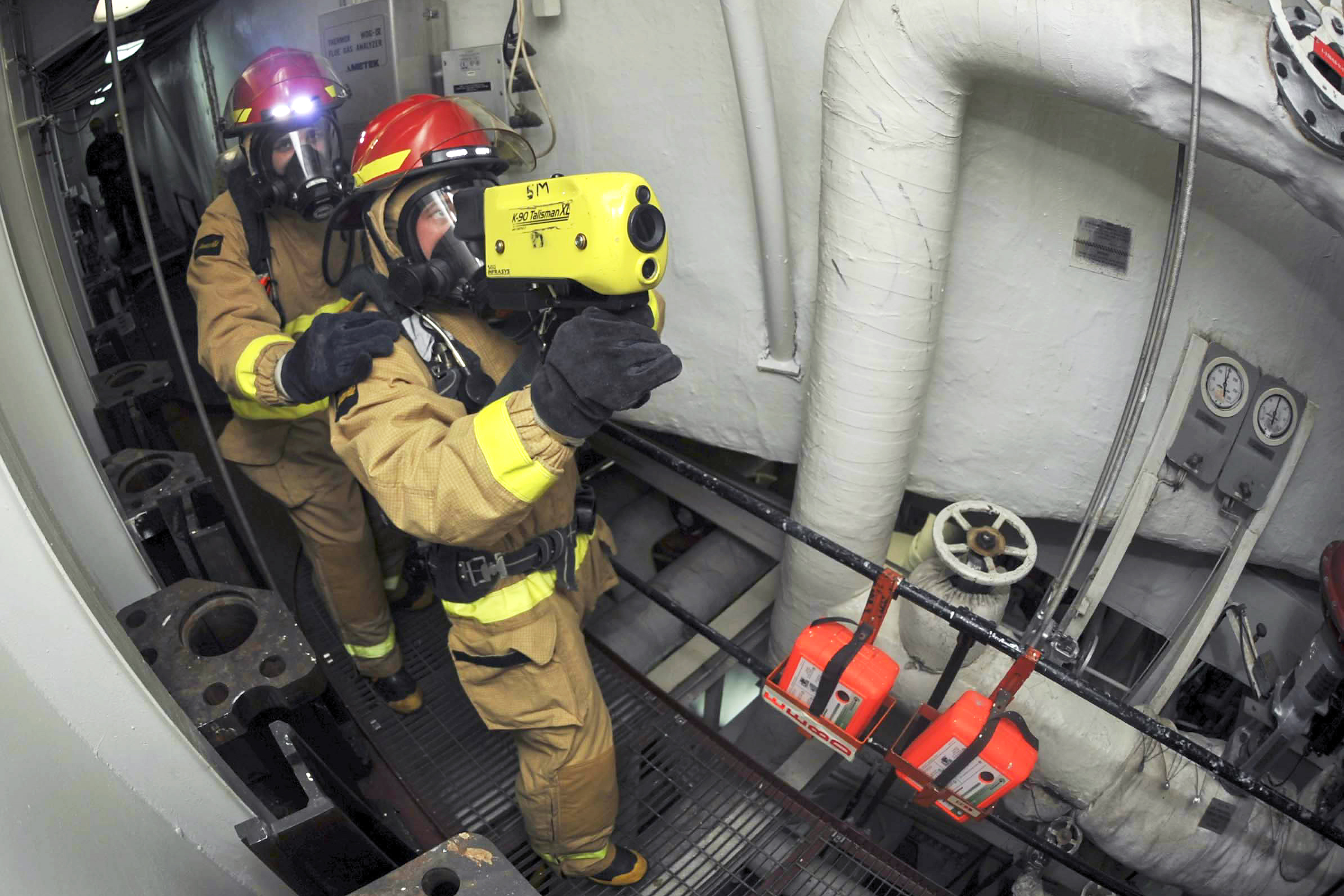 U.S. Navy Petty Officer 2nd Class Christian Karsemeyer, right, uses a ...