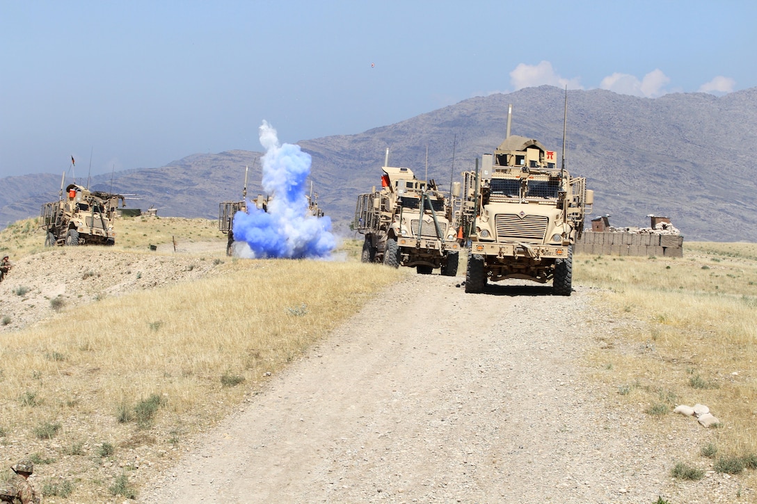A convoy of U.S. vehicles evades a simulated improvised explosive device, or roadside bomb, during a combined arms live-fire training exercise in Laghman province, Afghanistan, May 13, 2015. 