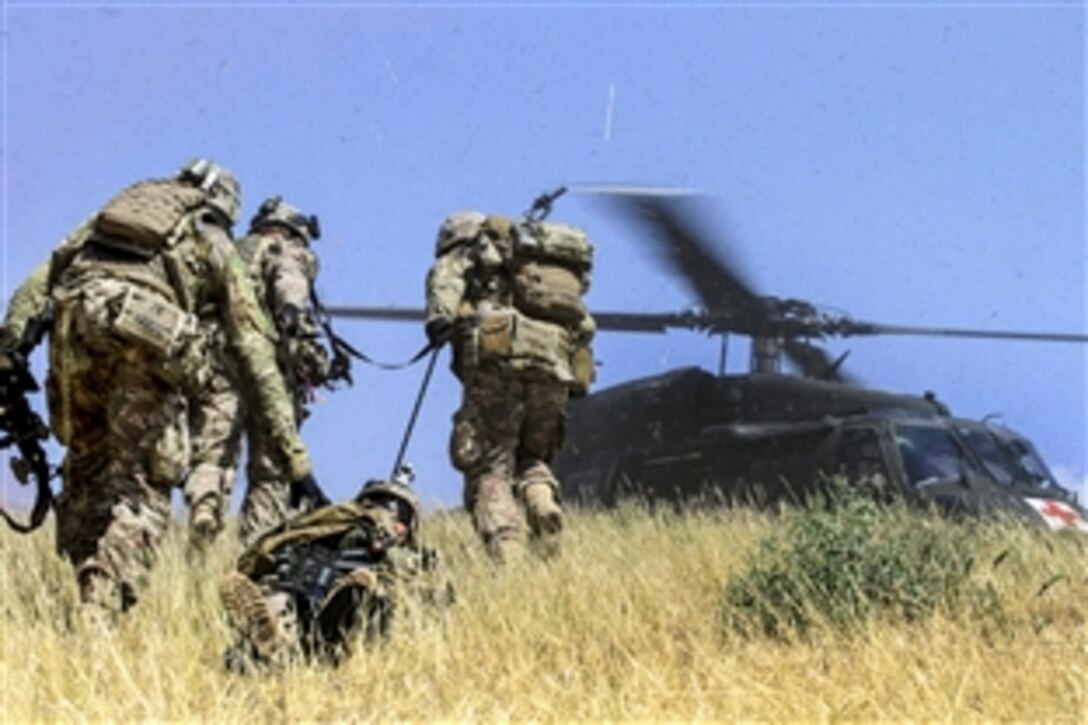 U.S. soldiers evacuate a simulated casualty during a combined arms live-fire training exercise in Laghman province, Afghanistan, May 13, 2015.  The soldiers are assigned to the 101st Airborne Division's 3rd Brigade Comabt Team. Train, Advise, Assist Command East conducted the exercise to demonstrate opportunities for the Afghan soldiers to plan, manage and conduct combined arms training on their ranges.