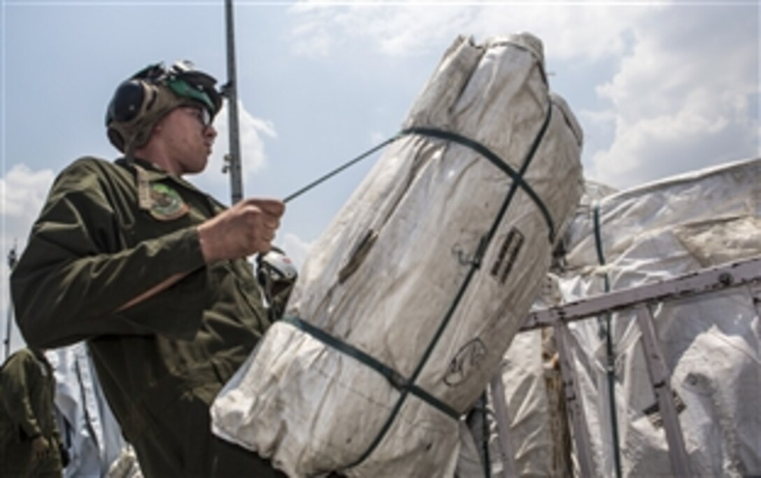 A U.S. service member assigned to Joint Task Force 505 prepares aid and relief supplies from the U.S. Agency for International Development at Tribhuvan International Airport in Kathmandu, Nepal, May 17, 2015. 