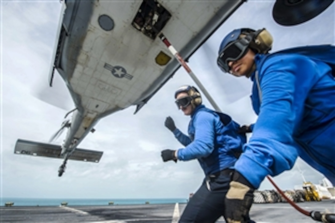 U.S. Navy Seamen Douglas McLain, left, and Cynthia Cea secure a hoist sling to an MH-60S Seahawk helicopter on the flight deck of the Military Sealift Command hospital ship USNS Comfort during flight operations to support Continuing Promise 2015 in the Caribbean Sea, May 17, 2015. The operation conducts humanitarian-civil assistance, subject matter expert exchanges, and medical, dental, veterinary and engineering support to partner nations. 