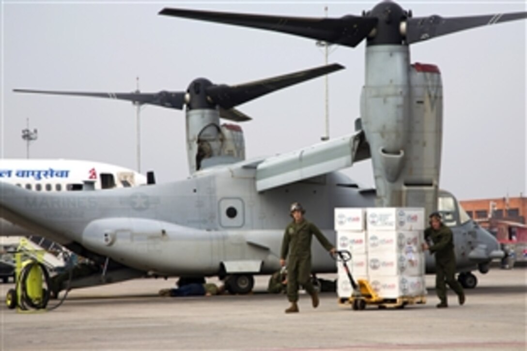 U.S. Service members assigned to Joint Task Force 505 transport relief supplies to a U.S. Marine Corps MV-22 Osprey at Tribhuvan International Airport, Kathmandu, Nepal, May 17, 2015. The supplies will be delivered to earthquake victims in remote areas of Nepal.