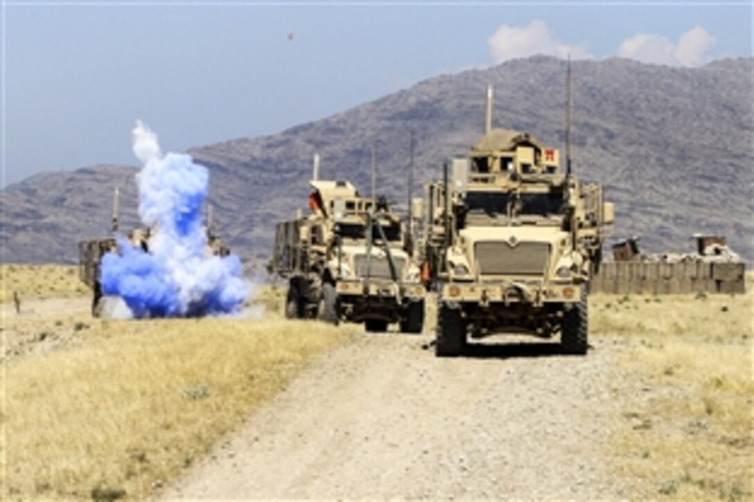 A convoy of U.S. vehicles evades a simulated improvised explosive device, or roadside bomb, during a combined arms live-fire training exercise in Laghman province, Afghanistan, May 13, 2015. The soldiers are assigned to the 101st Airborne Division's 3rd Brigade Comabt Team. Train, Advise, Assist Command East conducted the exercise to demonstrate opportunities for the Afghan soldiers to plan, manage and conduct combined arms training on their ranges. 