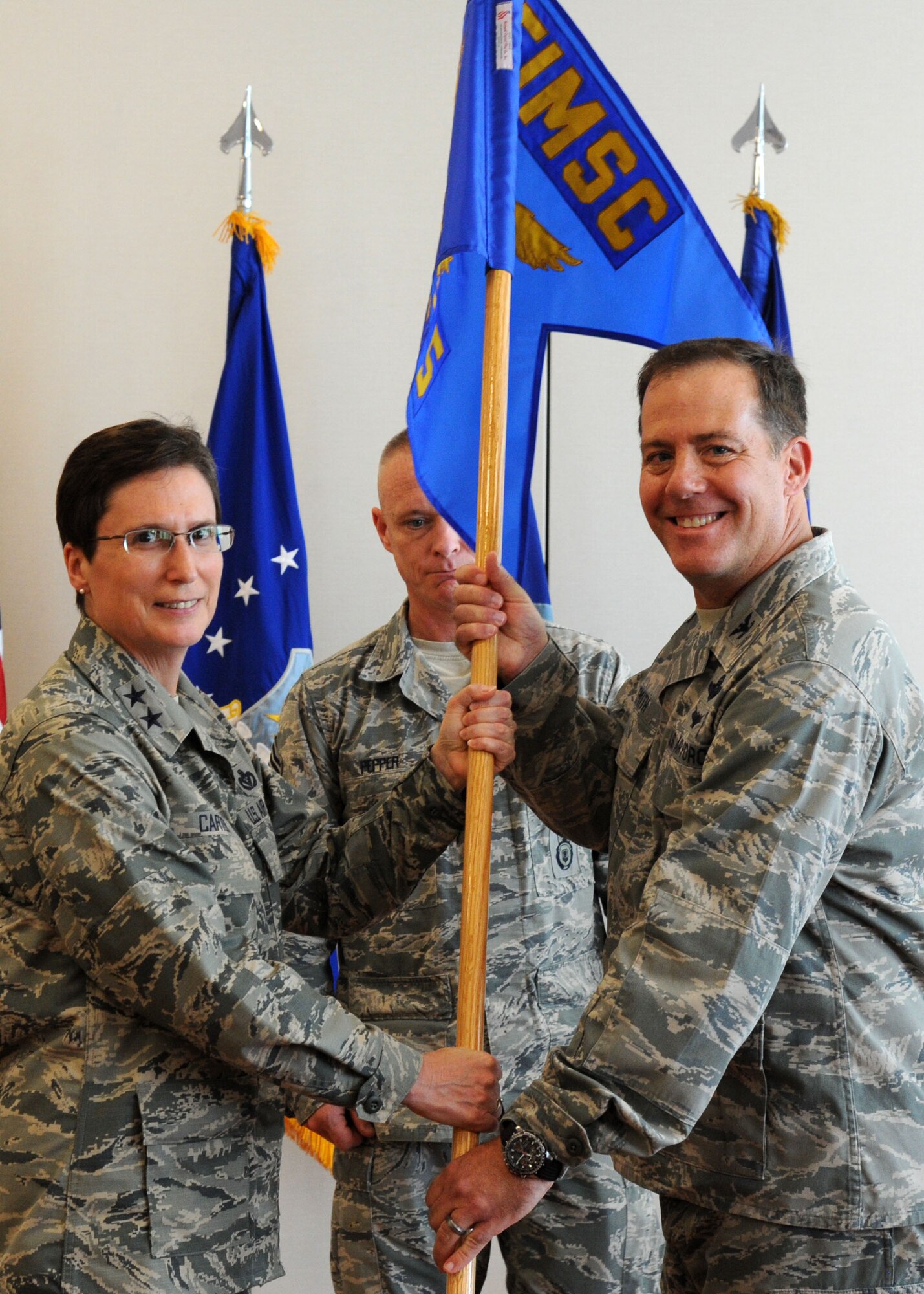 Col. Michael Smith assumes command of the Air Force Installation and Mission Support Center’s Detachment 5 from Maj. Gen. Theresa Carter during a ceremony at Joint Base Andrews, Maryland, May 18, 2015. Smith will serve as the interim commander of Detachment 5 which is the ninth of 10 AFIMSC detachments to be activated across the Air Force. Carter is the AFIMSC commander. (U.S. Air Force photo/Master Sgt. Tammie Moore)
