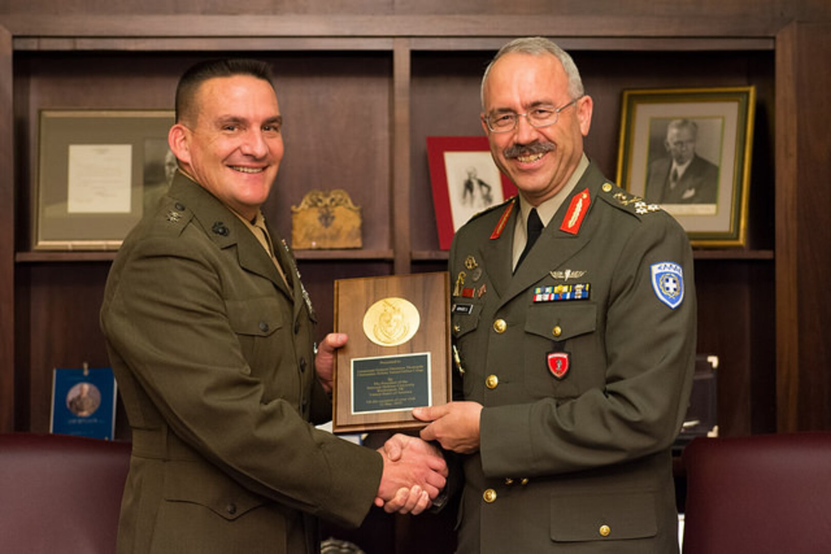 NDU President Major General Fred Padilla and LTG Dimitrios Thomaidis, Commandant of Greece's Hellenic National Defense College, exchange gifts.