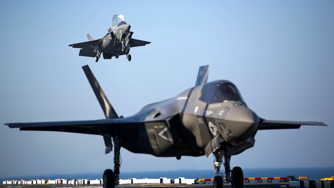 Two F-35B Lightning II Joint Strike Fighters complete vertical landings aboard the USS Wasp (LHD-1) during the opening day of the first session of operational testing, May 18, 2015. As the future of Marine Corps aviation, the F-35B will eventually replace all aircraft from three legacy Marine Corps platforms; th AV-8B Harrier, the F/A-18 Hornet, and the EA-6B Prowler. The aircraft are stationed with Marine Fighter Attack Training Squadron 501, Marine Aircraft Group 31, 2nd Marine Aircraft Wing, Beaufort, South Carolina and Marine Fighter Attack Squadron 121, Marine Aircraft Group 13, 3rd Marine Aircraft Wing, Yuma, Arizona. (U.S. Marine Corps photo by Lance Cpl. Remington Hall/Released)