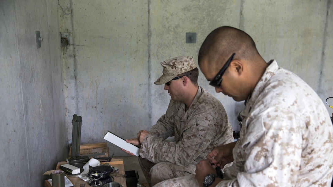 Explosive ordnance technicians with 2nd Explosive Ordnance Company, 8th Engineer Support Battalion, Staff Sgt. Unberto Rangel and Staff Sgt. Jacob Campbell, create improvised drop charges during a demolition exercise aboard Marine Corps Base Camp Lejeune, North Carolina, May 14, 2015. The exercise is part of the unit’s preparations for an upcoming deployment with Special Purpose Marine Air-Ground Task Force Crisis Response-Africa and gave Marines hands-on training with tools that allow them to neutralize hazards while causing minimal damage in urban settings.