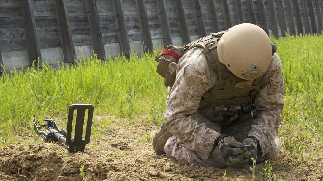 Staff Sgt. Philip Mayer, an explosive ordnance technician with 2nd Explosive Ordnance Company, 8th Engineer Support Battalion clears remnants of an improvised explosive device during a demolition exercise aboard Marine Corps Base Camp Lejeune, North Carolina, May 14, 2015. The exercise is part of the unit’s preparations for an upcoming deployment with Special Purpose Marine Air-Ground Task Force Crisis Response-Africa and gave Marines hands-on training with tools that allow them to neutralize hazards while causing minimal damage in urban settings. 