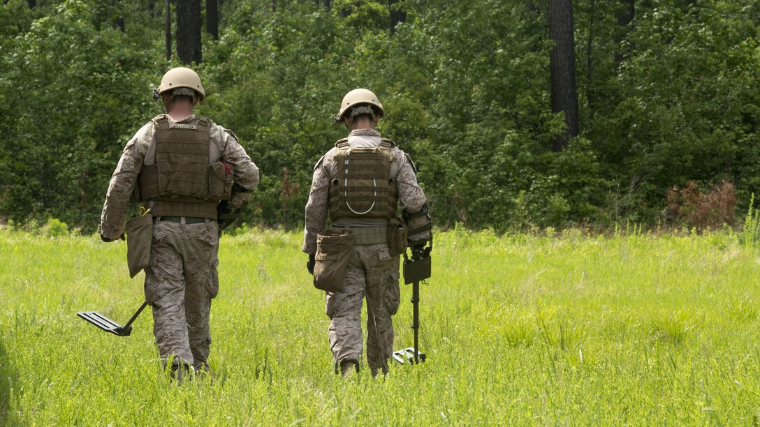 Explosive ordnance technicians with 2nd Explosive Ordnance Company, 8th Engineer Support Battalion patrol a field for improvised explosive devices using a compact metal detector during a demolition exercise aboard Marine Corps Base Camp Lejeune, North Carolina, May 14, 2015. The exercise is part of the unit’s preparations for an upcoming deployment with Special Purpose Marine Air-Ground Task Force Crisis Response-Africa and gave Marines hands-on training with tools that allow them to neutralize hazards while causing minimal damage in urban settings. 