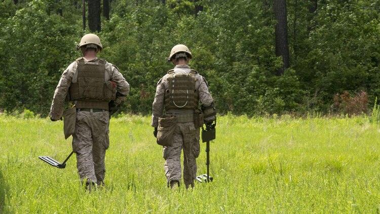 Explosive ordnance technicians with 2nd Explosive Ordnance Company, 8th Engineer Support Battalion patrol a field for improvised explosive devices using a compact metal detector during a demolition exercise aboard Marine Corps Base Camp Lejeune, North Carolina, May 14, 2015. The exercise is part of the unit’s preparations for an upcoming deployment with Special Purpose Marine Air-Ground Task Force Crisis Response-Africa and gave Marines hands-on training with tools that allow them to neutralize hazards while causing minimal damage in urban settings. 