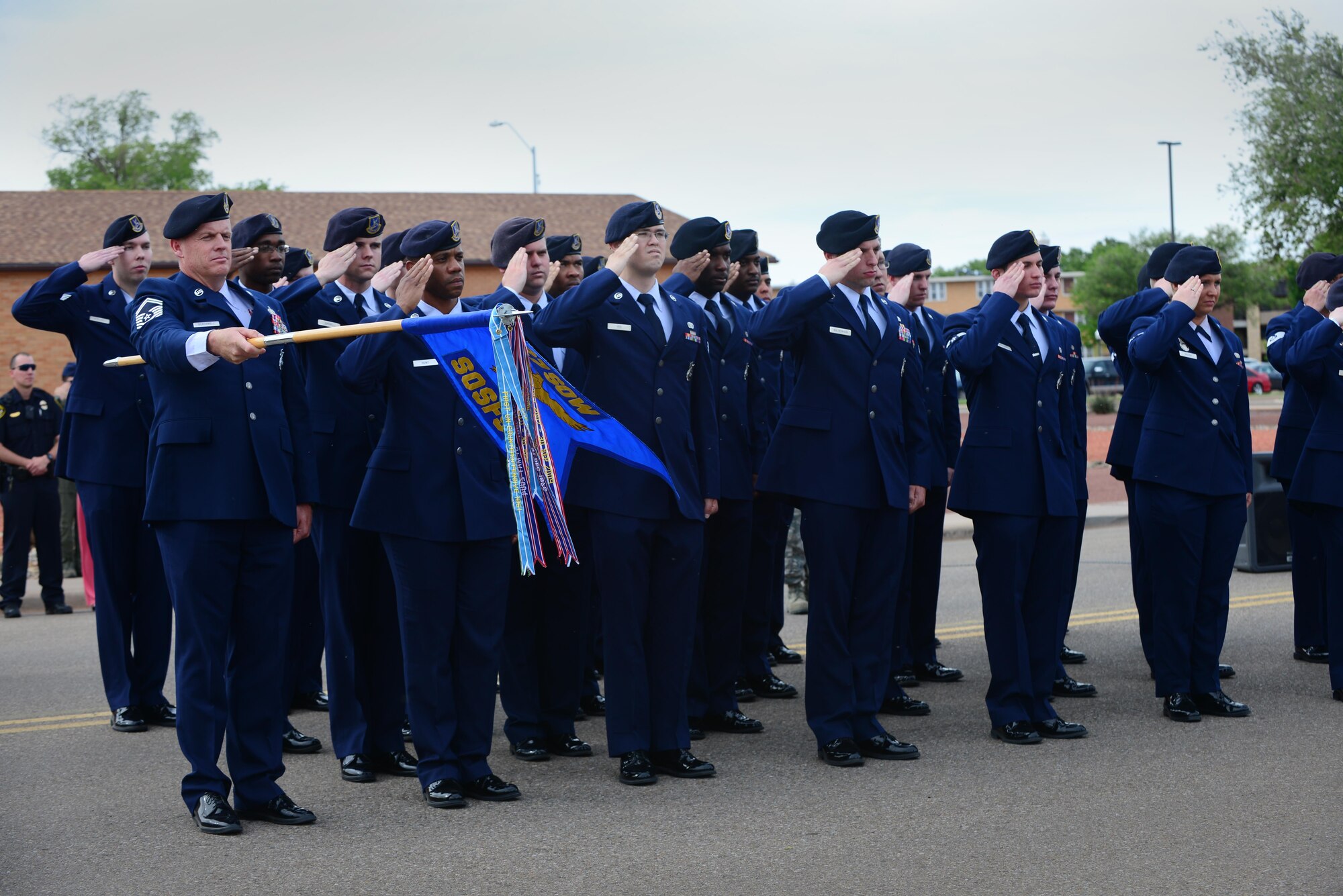 Air Commandos from the 27th Special Operations Security Forces Squadron salute the flag during a combined memorial ceremony and retreat May 14, 2015 at Cannon Air Force Base, N.M. The ceremony honored 146 peacekeepers who fell in the line of duty in 2014 in addition to those who continue to serve today. (U.S. Air Force Photo/Airman 1st Class Shelby Kay-Fantozzi)