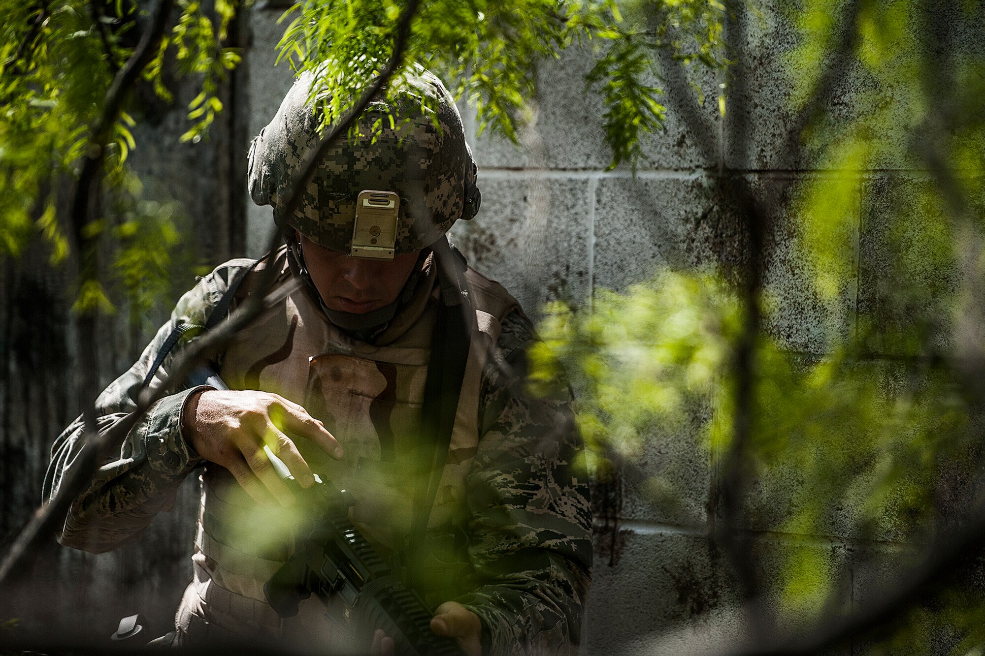 GOODFELLOW AIR FORCE BASE, Texas – Todd M. Duquette, Angelo State University Air Force ROTC Detachment 847 cadet, charges his weapon during a field training exercise at a deployed simulation village near Camp Sentinel April 18. Among other things in the FTX, Duquette learned about civil affairs, entry controller procedures and how to handle enemy prisoners of war. (U.S. Air Force photo/ Airman 1st Class Devin Boyer)
