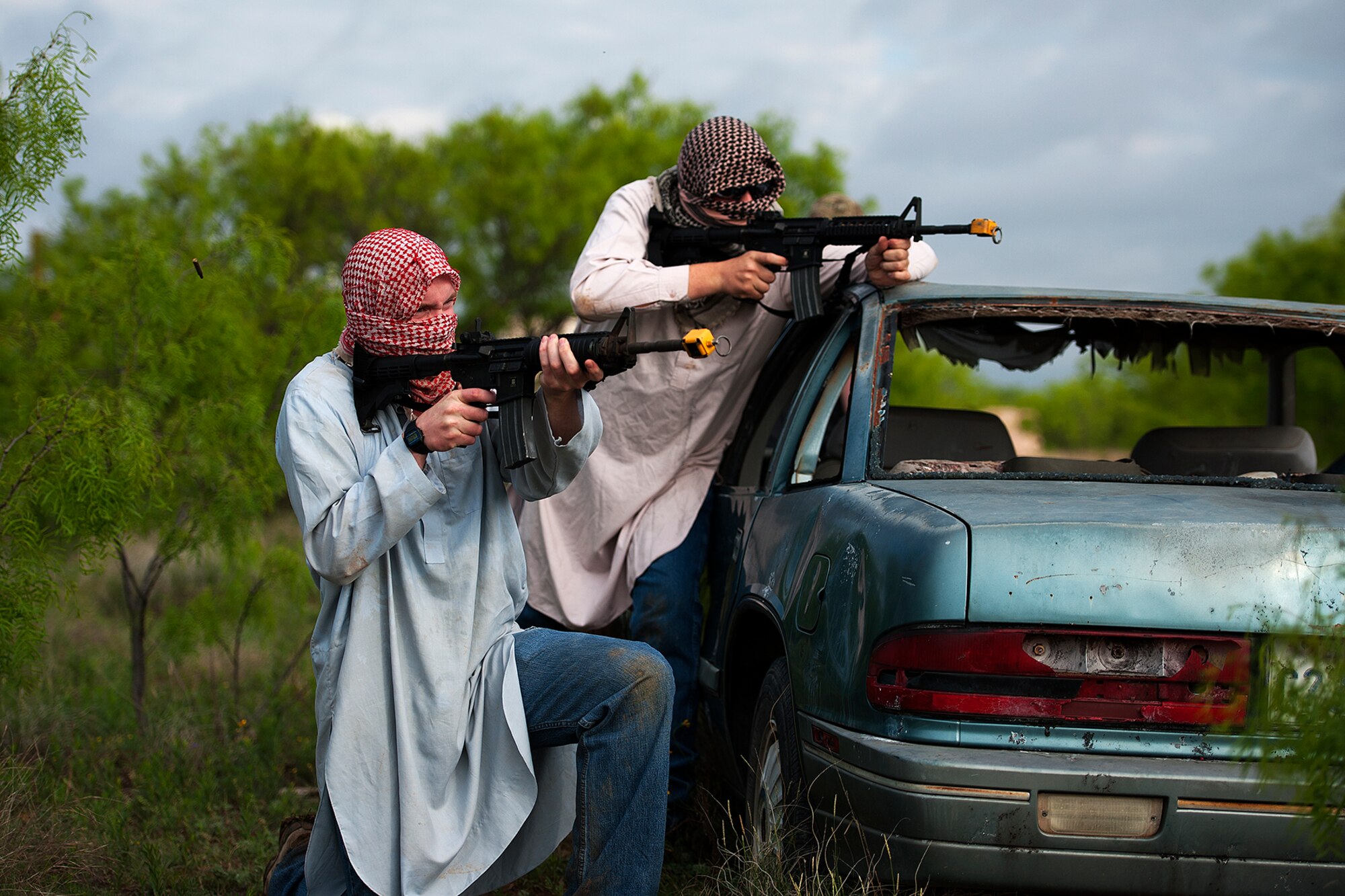 GOODFELLOW AIR FORCE BASE, Texas -- 316th Training Squadron students shoot blanks at Angelo State University Air Force ROTC Detachment 847 cadets during a field training exercise at a deployed simulation village near Camp Sentinel April 18. The students dressed up in middle eastern attire to create a more realistic scenario. (U.S. Air Force photo/ Airman 1st Class Devin Boyer)