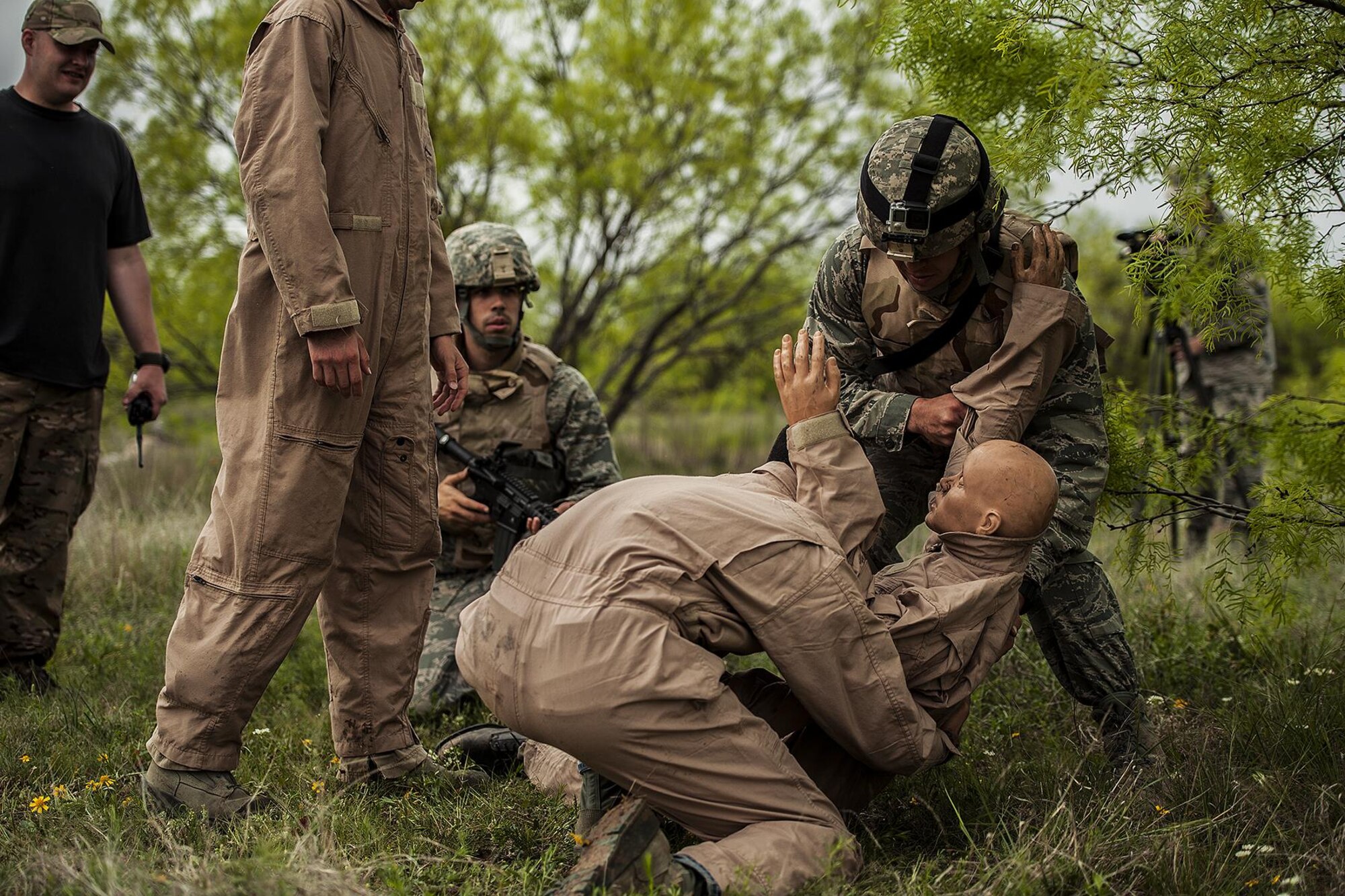 GOODFELLOW AIR FORCE BASE, Texas – Todd M. Duquette, Angelo State University Air Force ROTC Detachment 847 cadet, right, lifts a dummy with Goodfellow members during a field training exercise at a deployed simulation village near Camp Sentinel April 18. The scenario trained the cadets on search and rescue operations. (U.S. Air Force photo/ Airman 1st Class Devin Boyer)