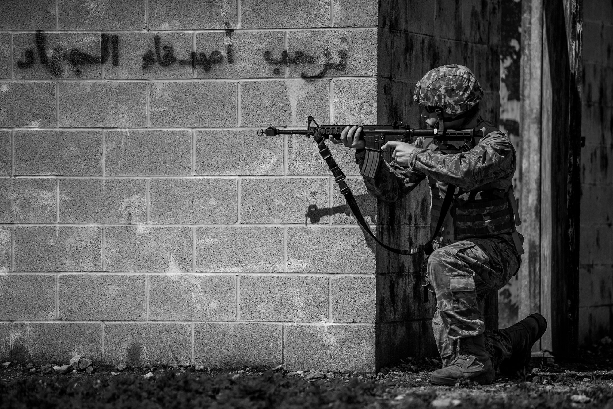 GOODFELLOW AIR FORCE BASE, Texas – Wyatt J. Bersch, Angelo State University Air Force ROTC Detachment 847 cadet, aims his weapon toward enemy fire during a field training exercise at a deployed simulation village near Camp Sentinel April 18. The village consists of a middle eastern theme creating a more realistic deployed environment. (U.S. Air Force photo/ Airman 1st Class Devin Boyer)