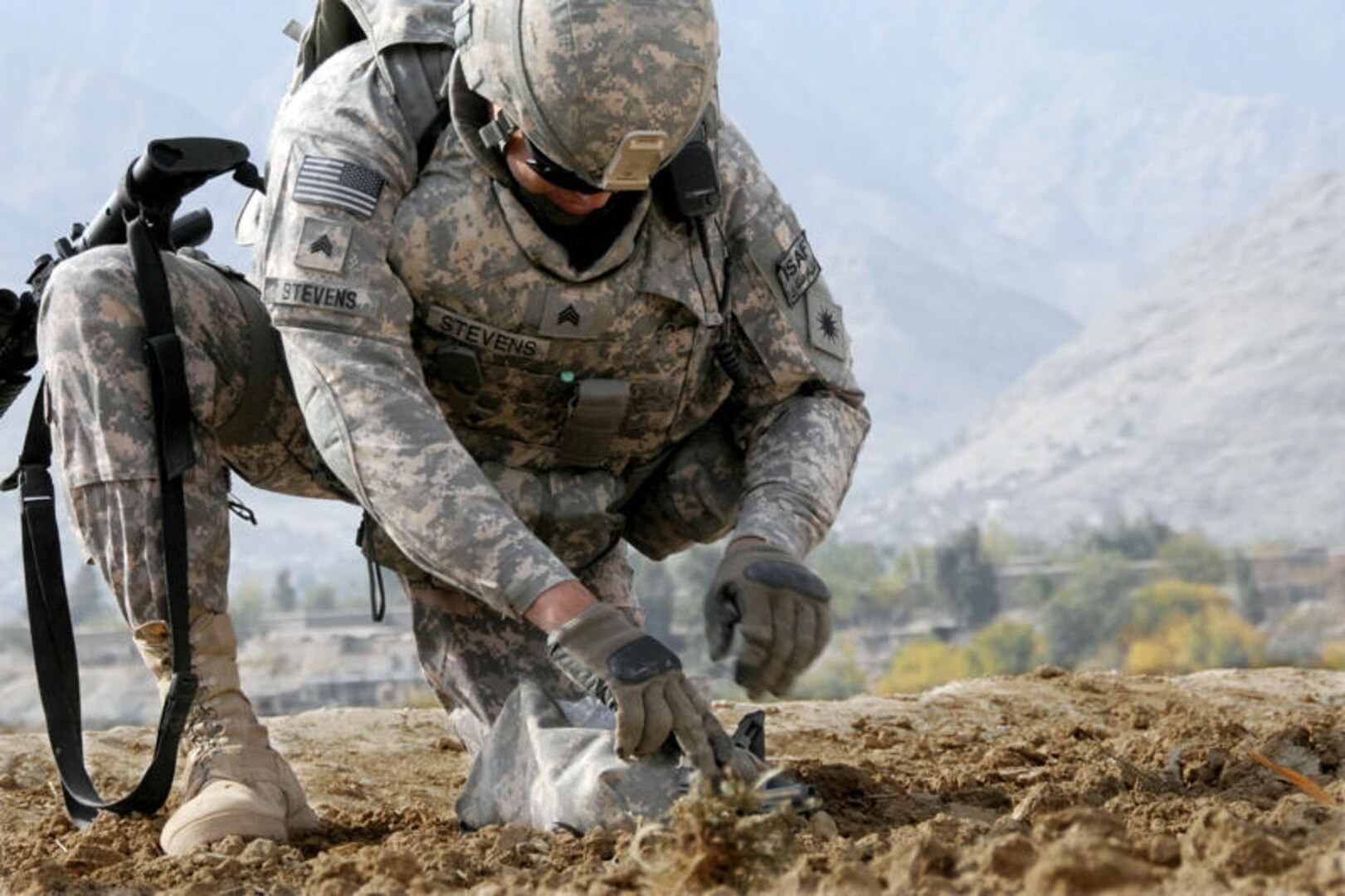 Sgt. Jason Stevens, a horticulturist with the California Army National Guard's 40th Infantry Division Agribusiness Development Team, gathers a soil sample from a field alongside the main road in Marawara, Afghanistan, on Nov. 23, 2009. The ADT stopped in Marawara to meet with local farmers about their crop output and farming in the area, as well as to gather soil samples to learn how crop production might be increased in the area.