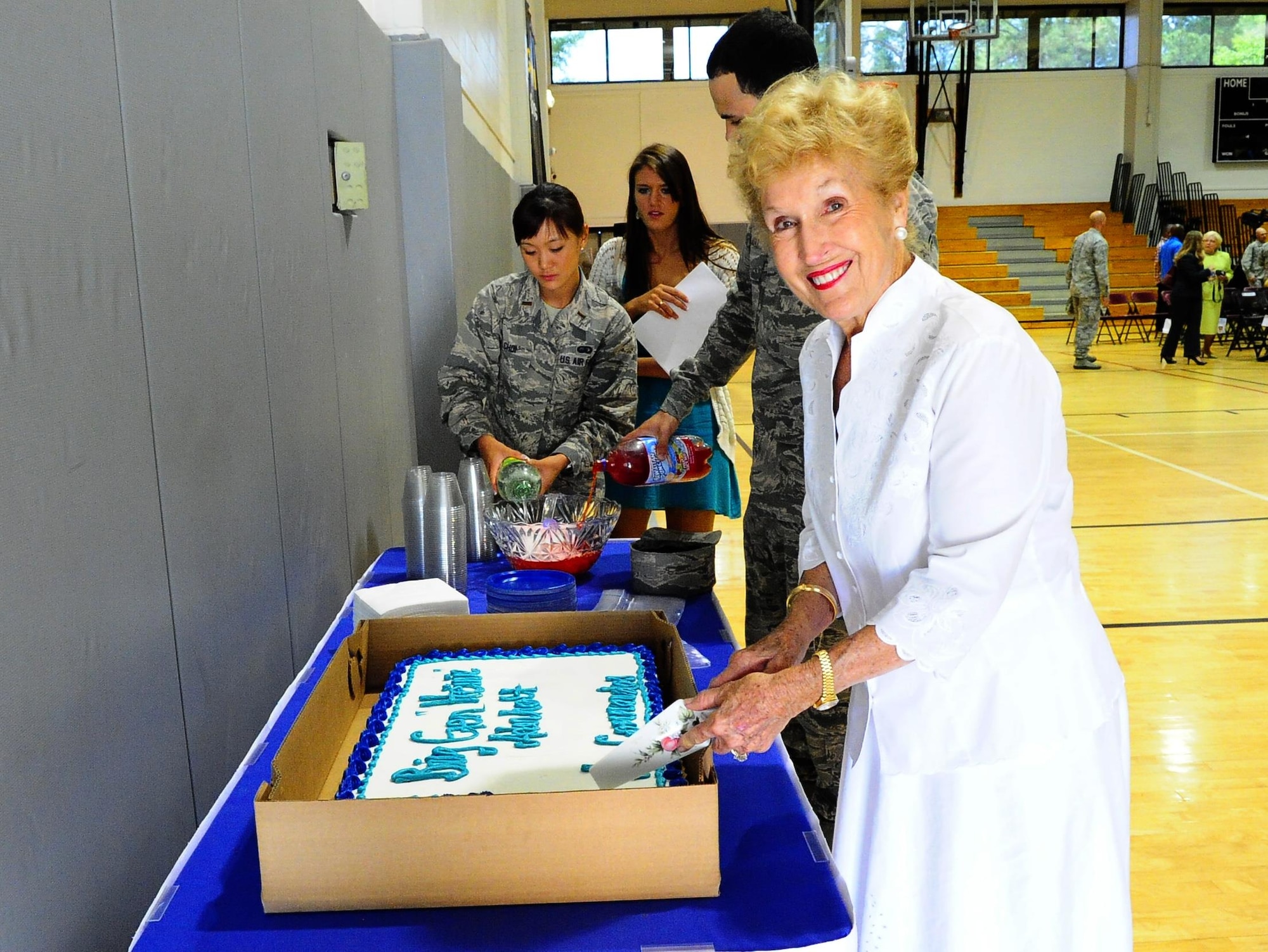 Anne Aderholt, widow of Brig. Gen.  Harry Aderholt, cuts the cake after the Aderholt Display unveiling ceremony at the Aderholt Fitness Facility on Hurlburt Field, Fla., May 11, 2015. Aderholt served as the vice commander and then commander of the 1st Air Commando Wing at Hurlburt Field, a predecessor of the 1st Special Operations Wing, from March 1964 until August 1965. Hurlburt Field named the main fitness facility after General Aderholt in 2004. (U.S. Air Force photo/Airman 1st Class Andrea Posey)
