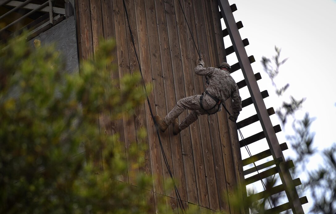 A Marine rappels down the rappel tower May 14,2015 to prepare for the 2015 Recon Challenge. This 30-mile gauntlet tests Marines' physical and mental strength during exercises such as finning, live fire, and pool events. Competetors carry flags of the names of fallen Recon Marines to keep their memory alive. (U.S. Marine Corps photo by Sgt. Ally Beiswanger/Released)