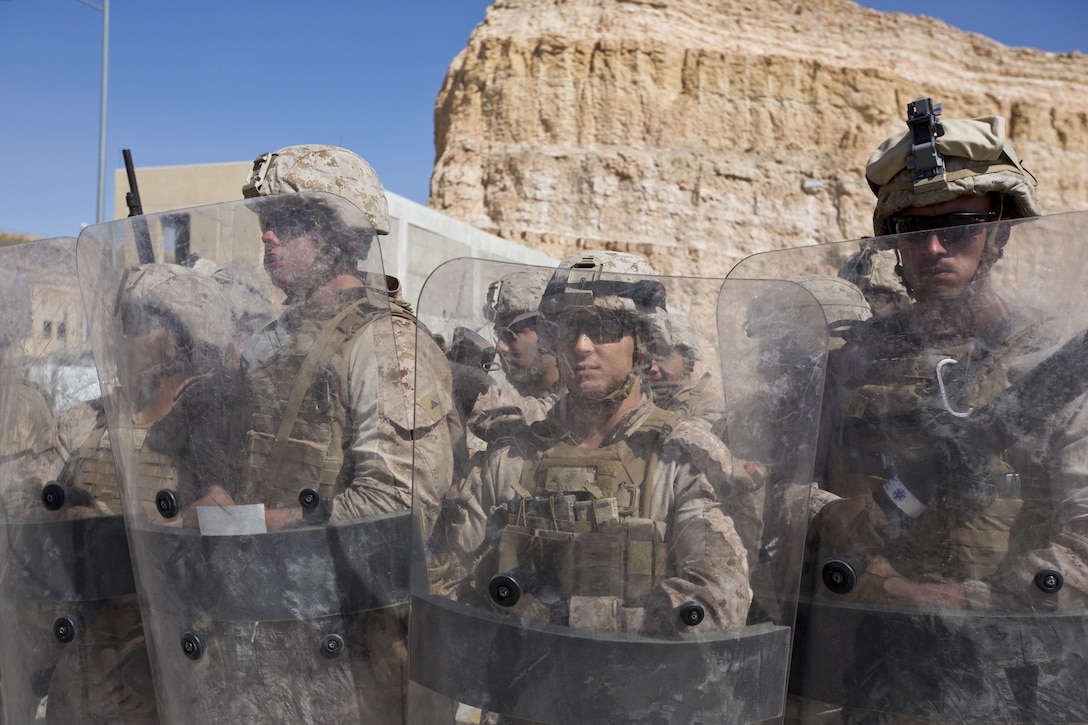 U.S. Marines with India Company, 3rd Battalion, 7th Marine Regiment, Special Purpose Marine Air-Ground Task Force-Crisis Response, Central Command, perform riot control techniques during a non-combatant evacuation operation as part of Exercise Eager Lion at the King Abdullah Special Operations Training Center in Amman, Jordan, May 15, 2015. Eager Lion is a recurring, multinational exercise designed to strengthen military-to-military relationships, increase interoperability between partner nations and enhance regional security and stability. 