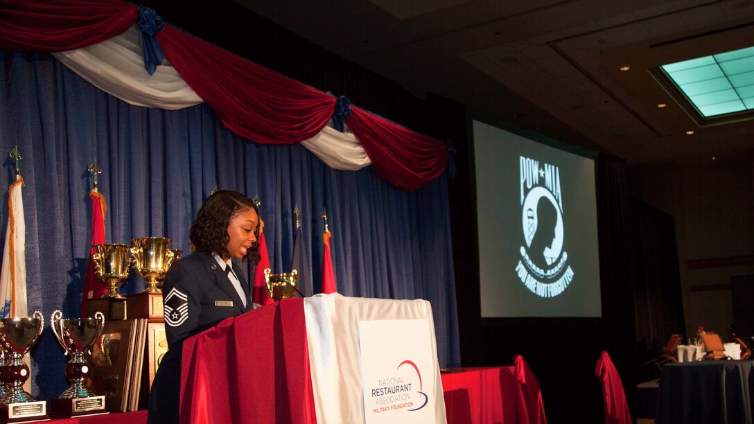 Senior Master Sgt. Melody Goitom presents the Prisoner of War/Missing in Action table during 2015 Armed forces Food Service Awards Dinner, May 15, at the Sheraton Chicago Hotel in Chicago. The event honored service members from all branches of the Department of Defense and the Coast Guard for excellence in food services and preparation in the military. 
